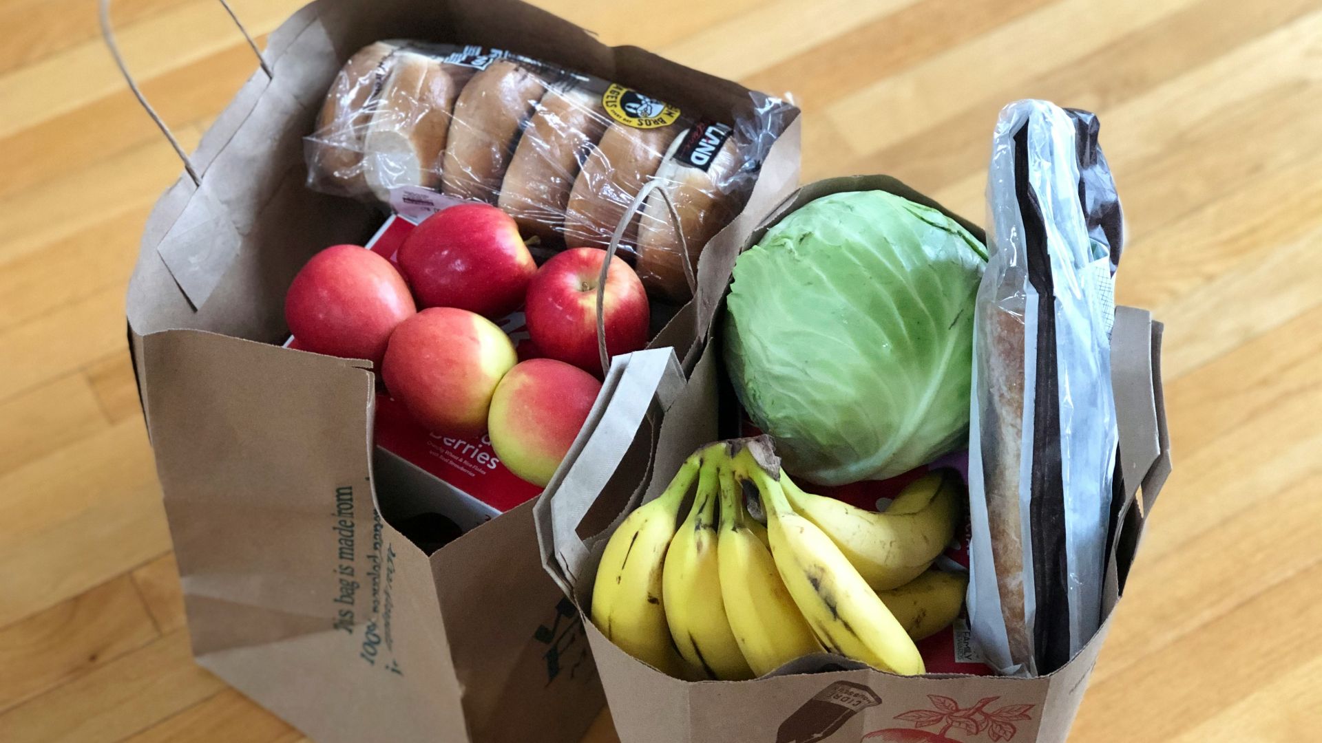 apples and bananas in brown cardboard box