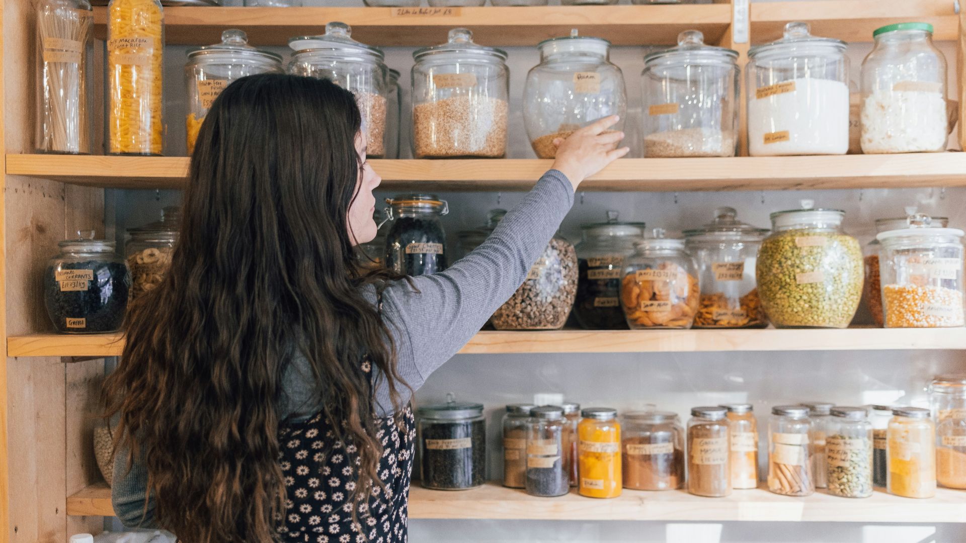 a person holding a jar of food