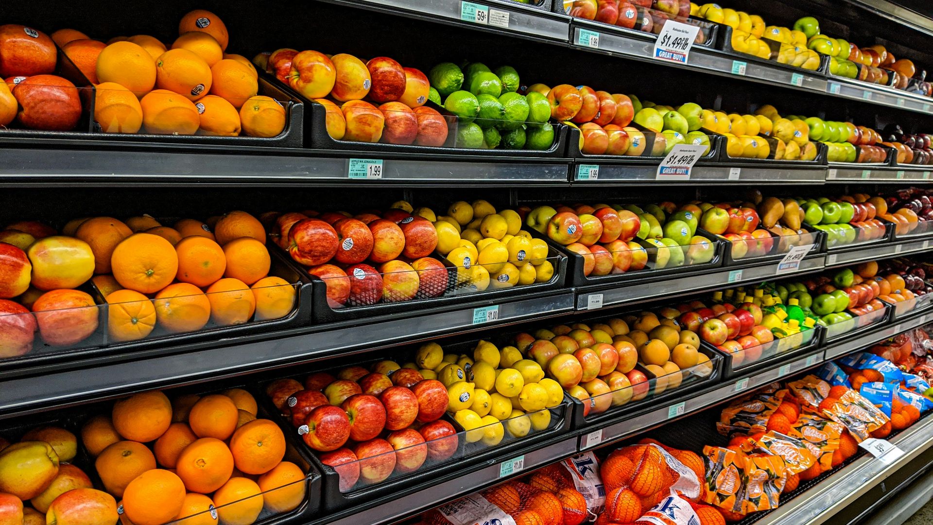 yellow and red apples on black plastic crate