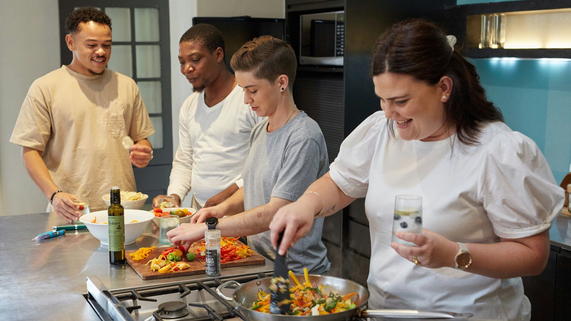 a group of people preparing food in a kitchen