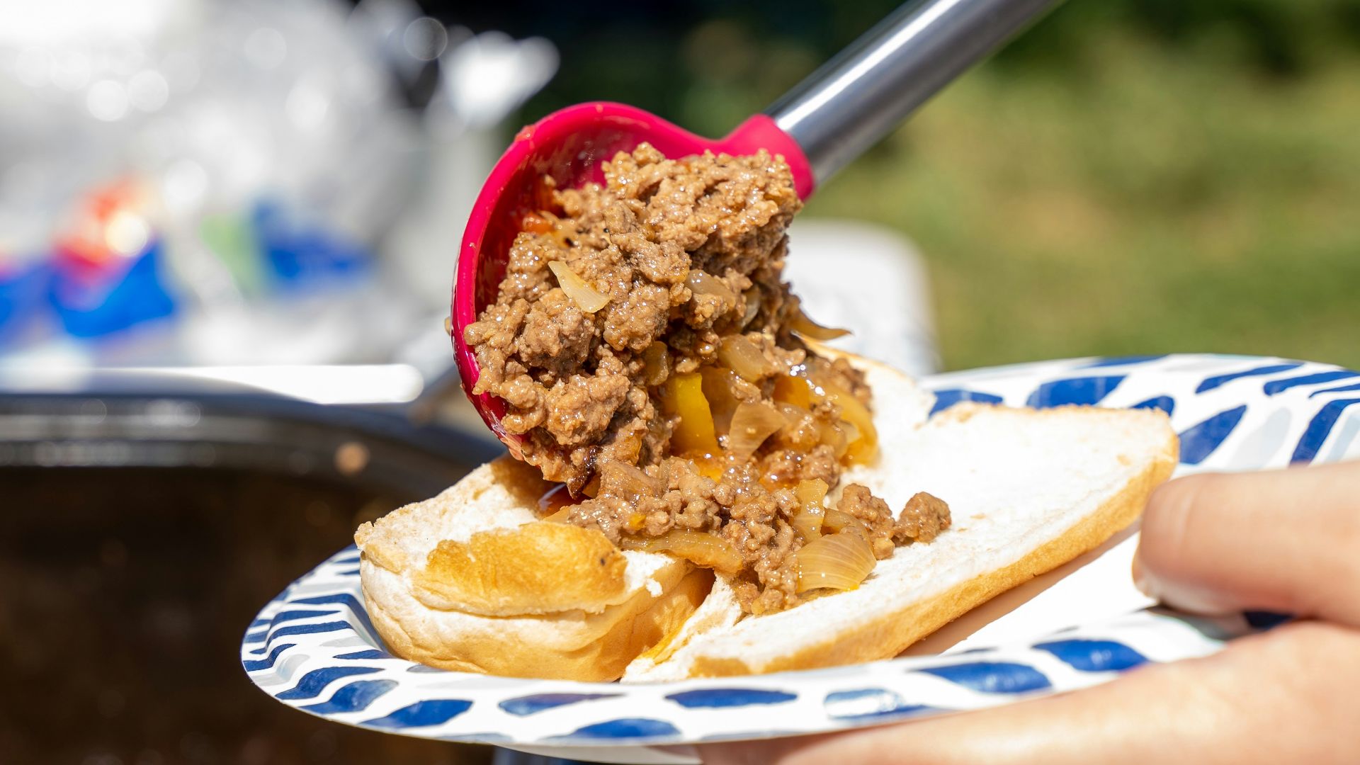 a person cutting a cake with a knife