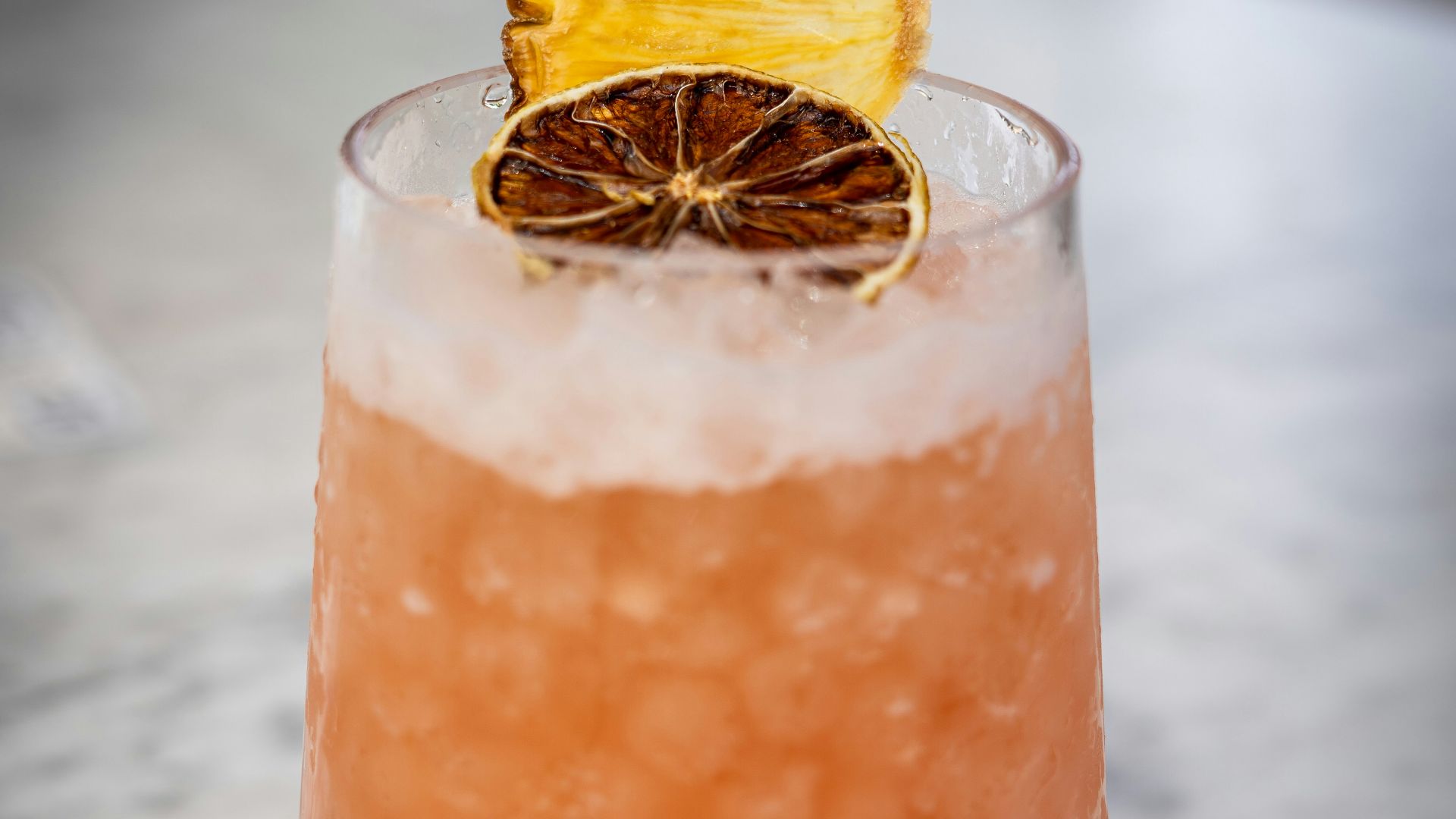 a drink with a slice of orange on top of it