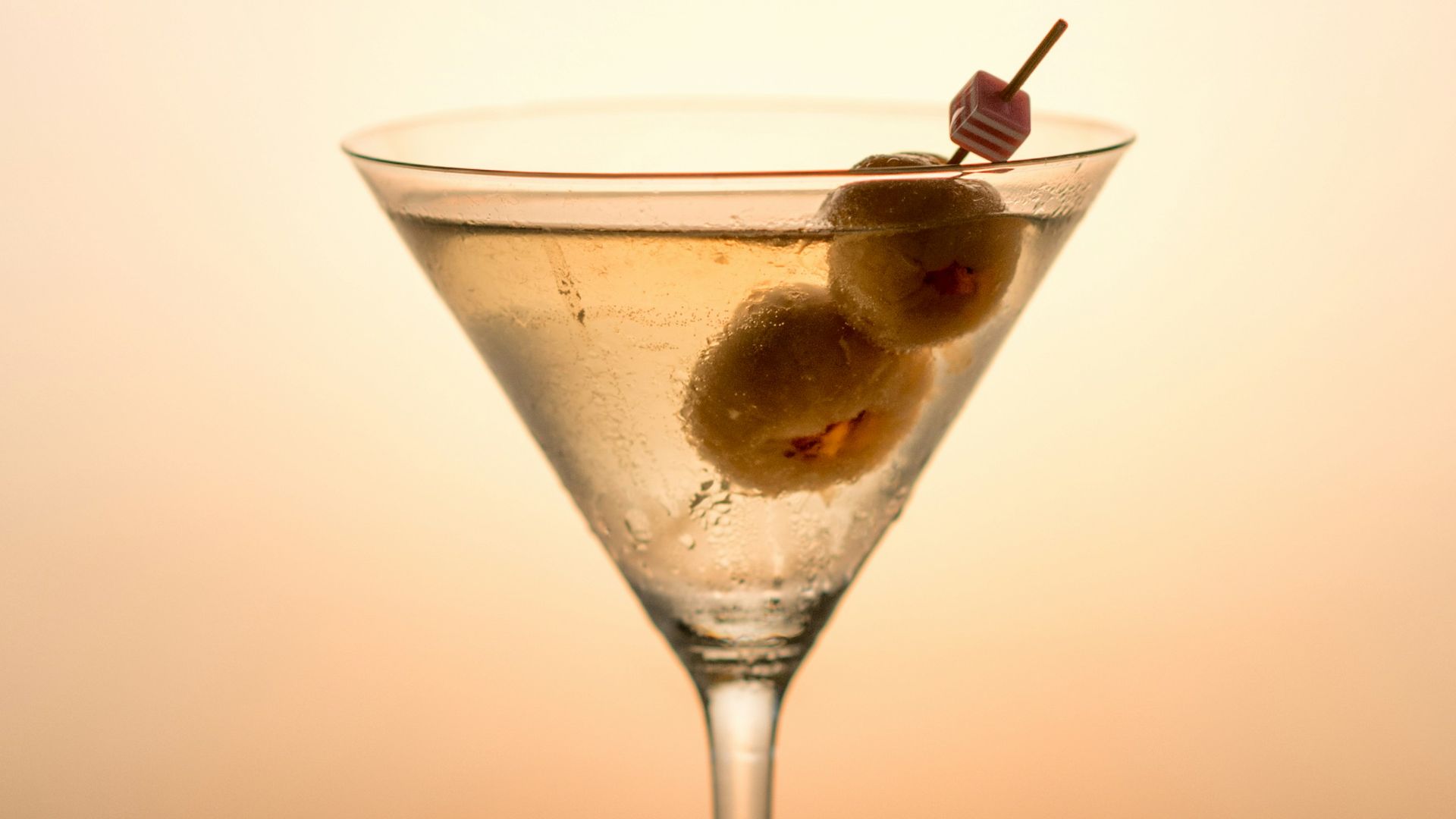 clear cocktail glass with yellow liquid