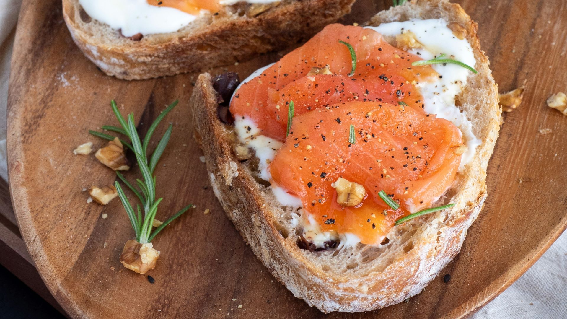sliced bread with sliced tomato on brown wooden chopping board