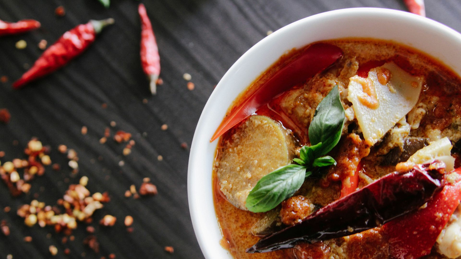 flat-lay photography of vegetable soup on white ceramic cup