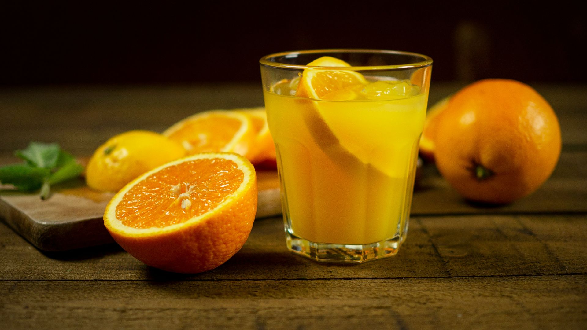 orange juice in clear drinking glass