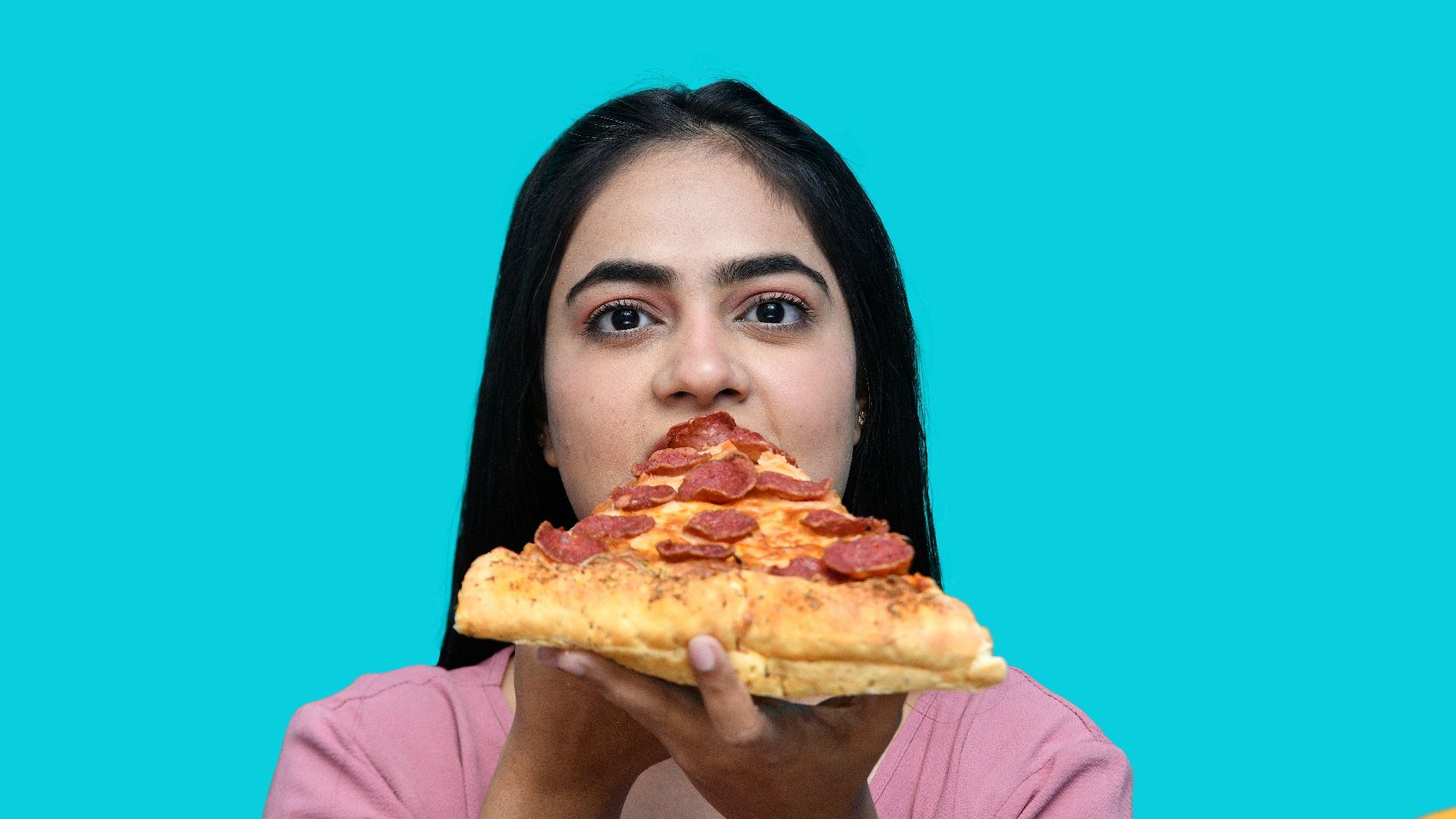 a woman eating a slice of pizza