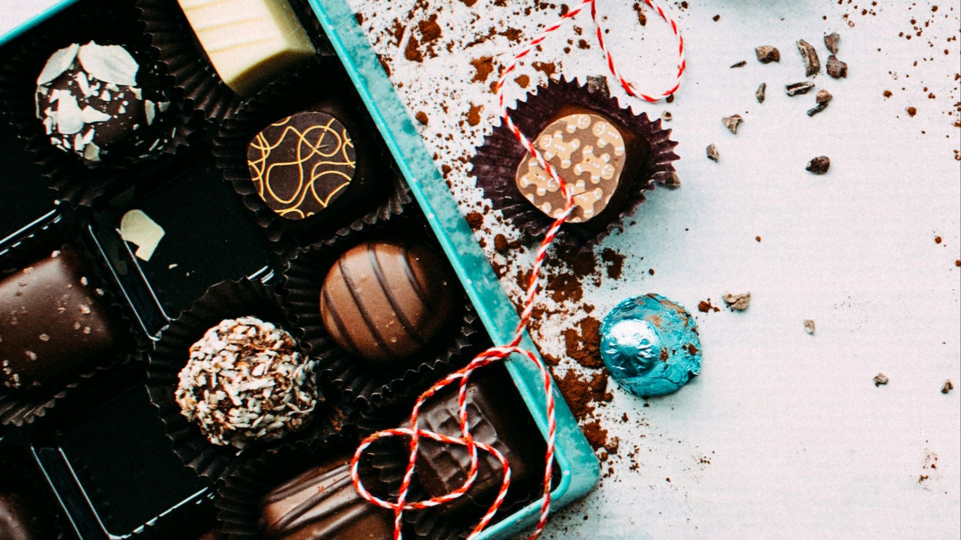 chocolates with box on white surface