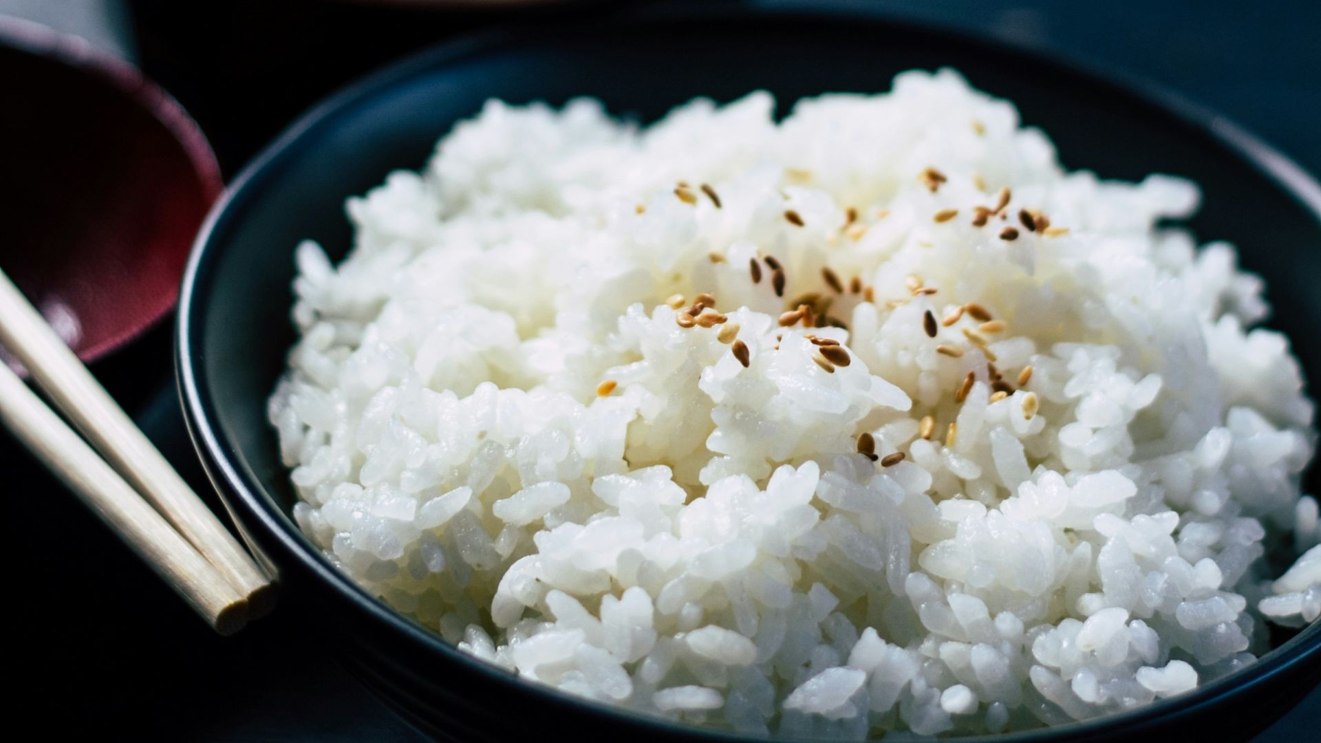 rice with sesame in black bowl
