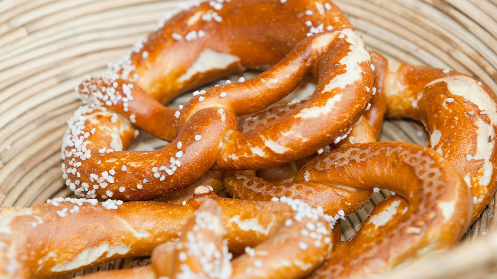 a basket filled with pretzels covered in powdered sugar