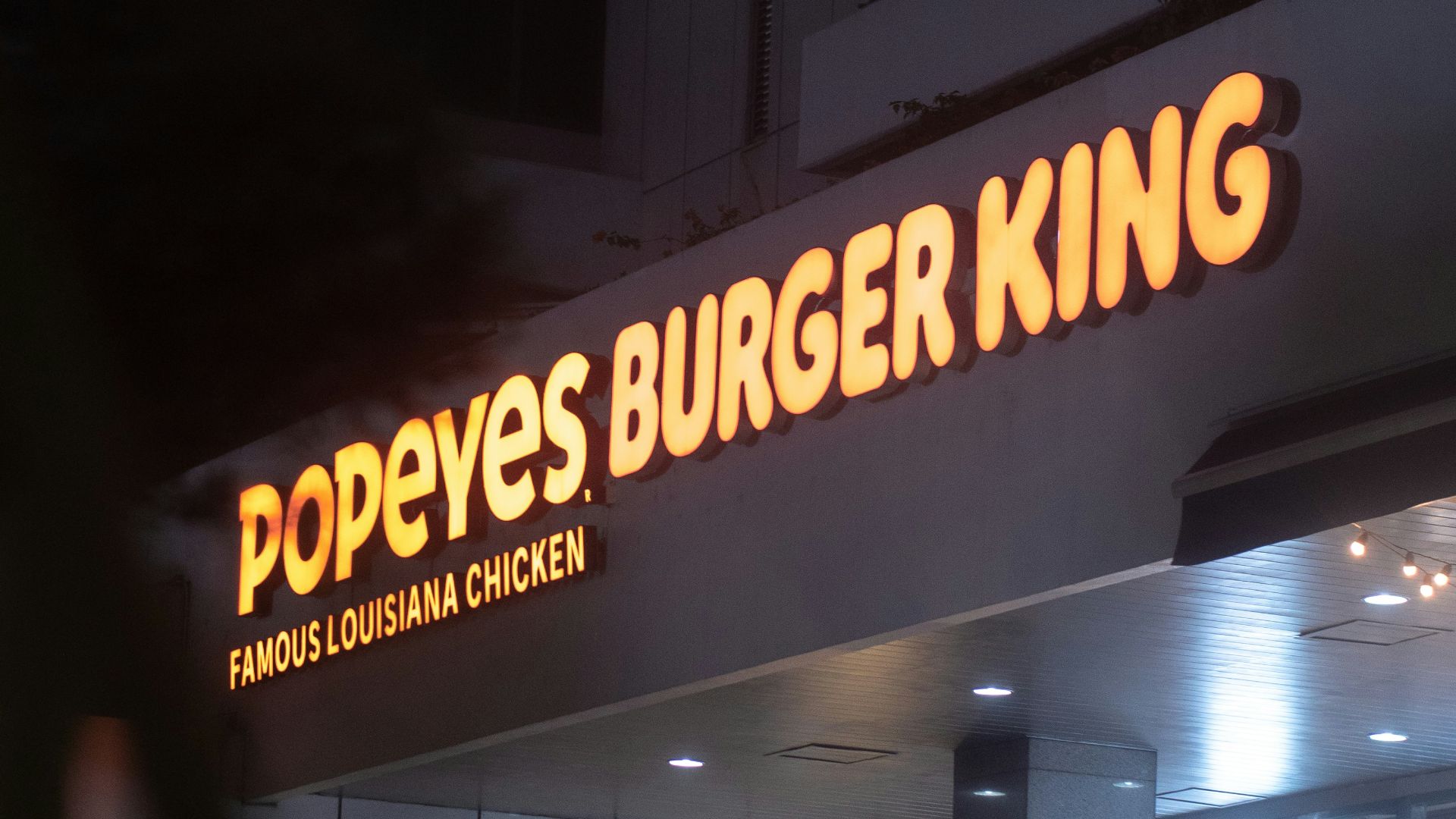 a burger king sign is lit up at night