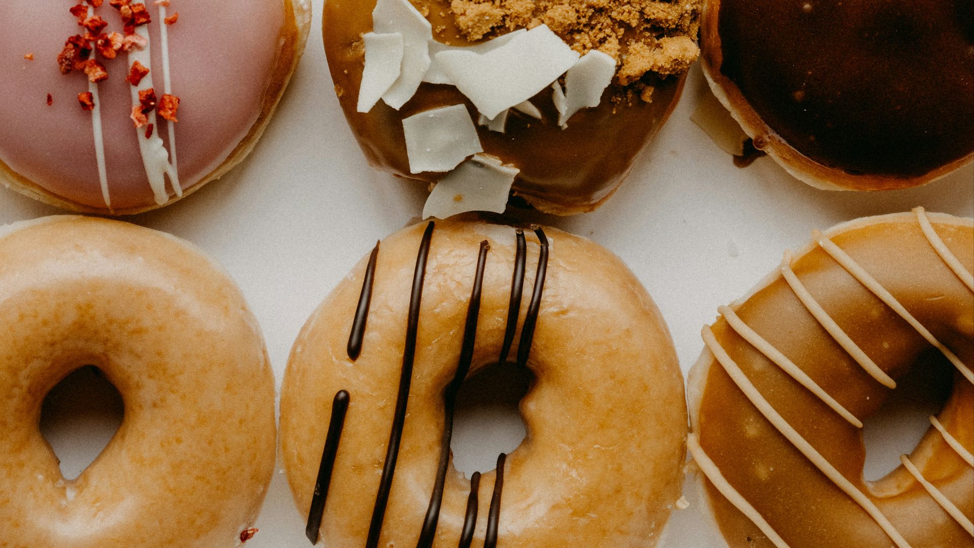 brown and white doughnuts on white ceramic plate