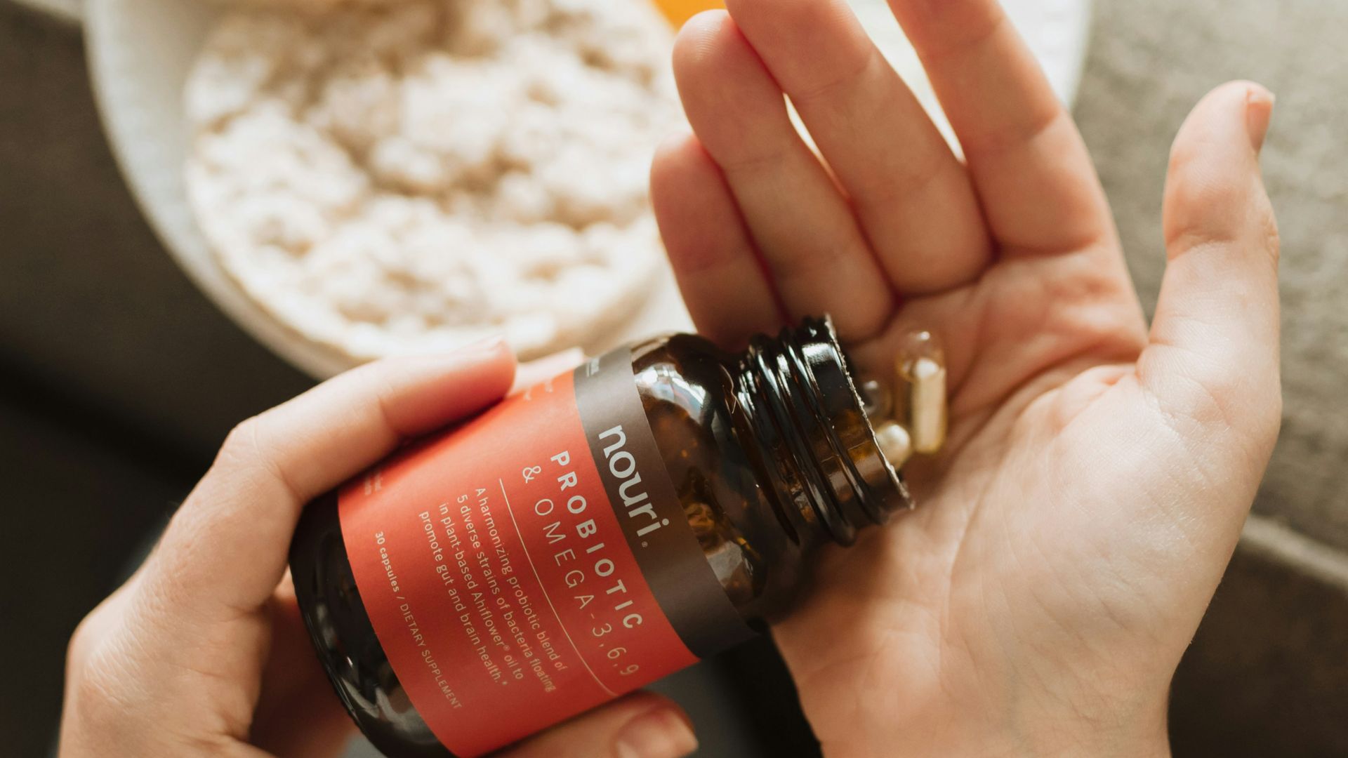 person holding red bottle