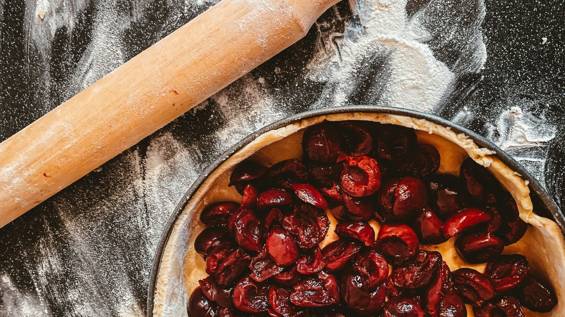 brown wooden rolling pin on stainless steel bowl