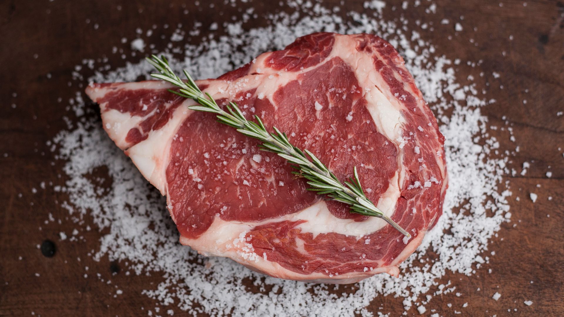 raw meat on brown wooden table