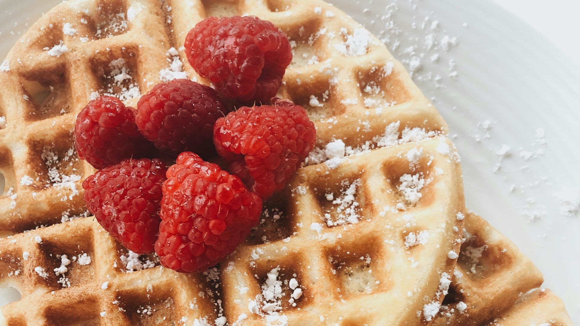 red strawberries on brown waffles