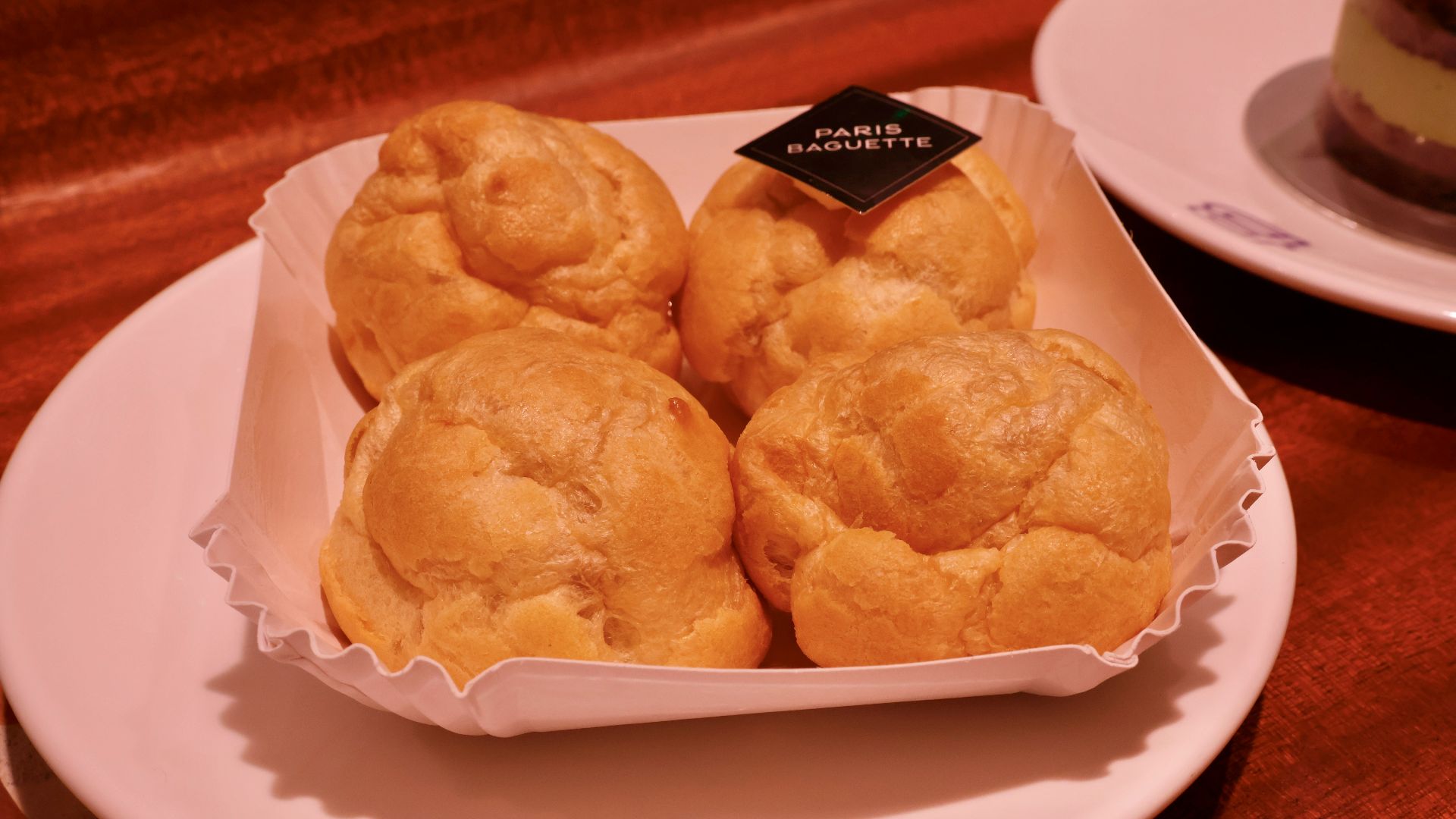 a white plate topped with pastries on top of a wooden table