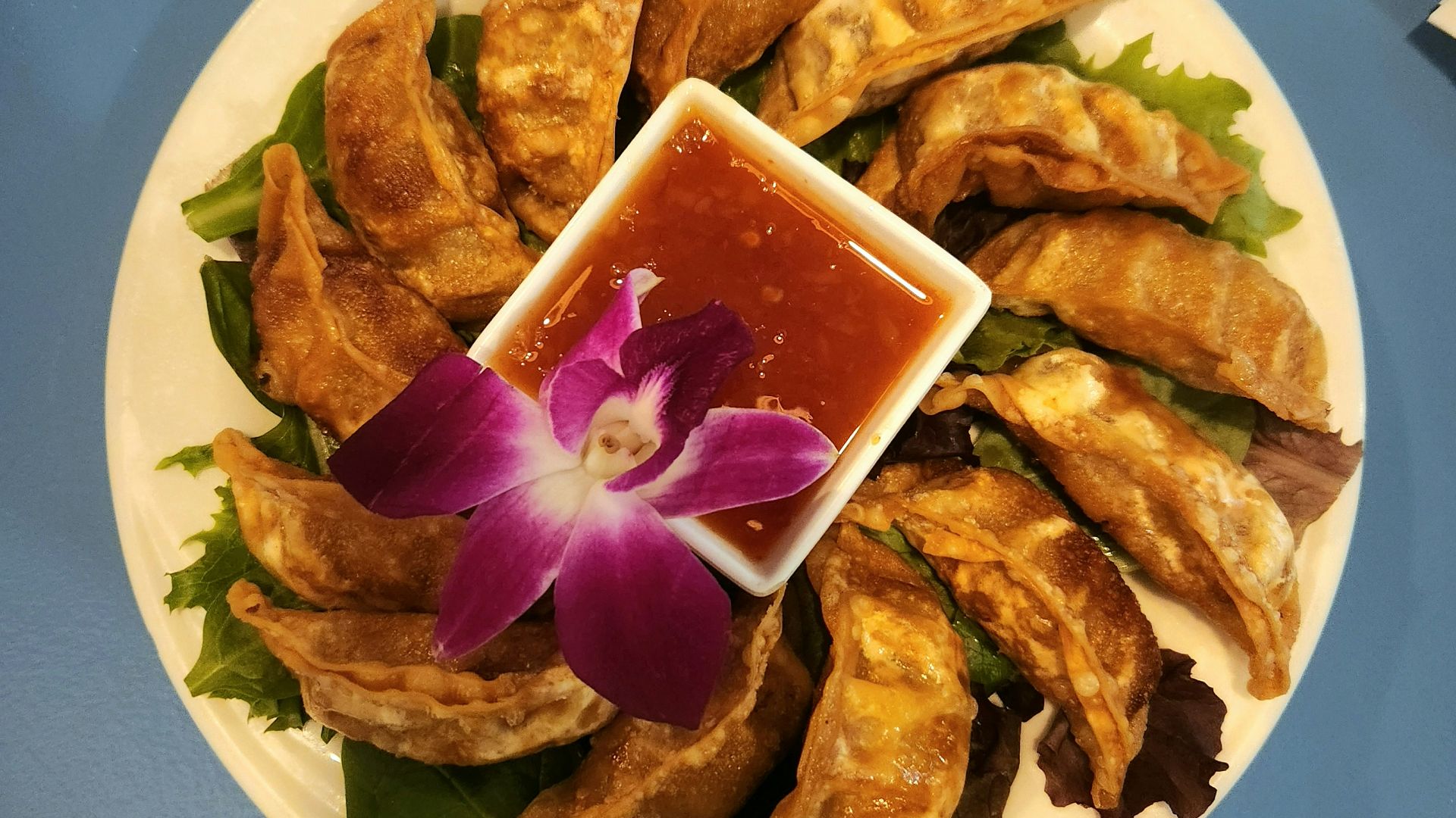 a plate of food with a flower on it