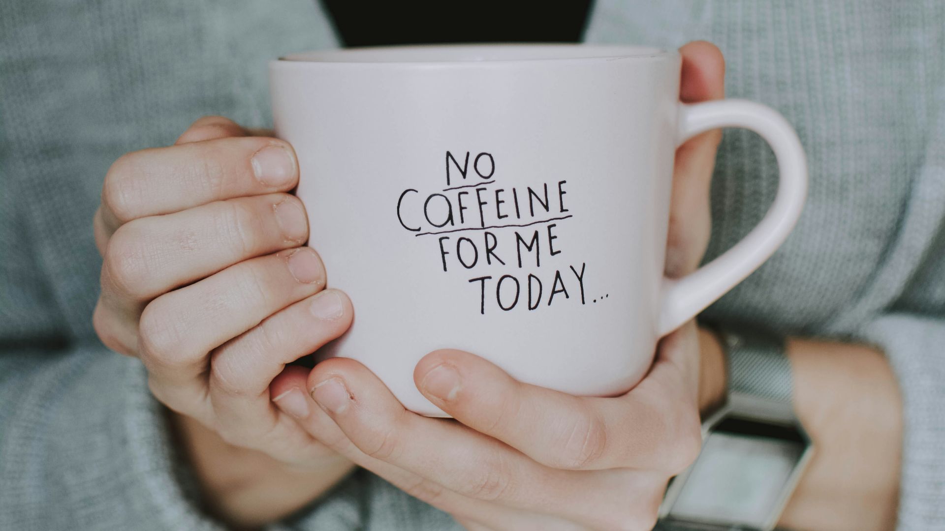woman holding white cup