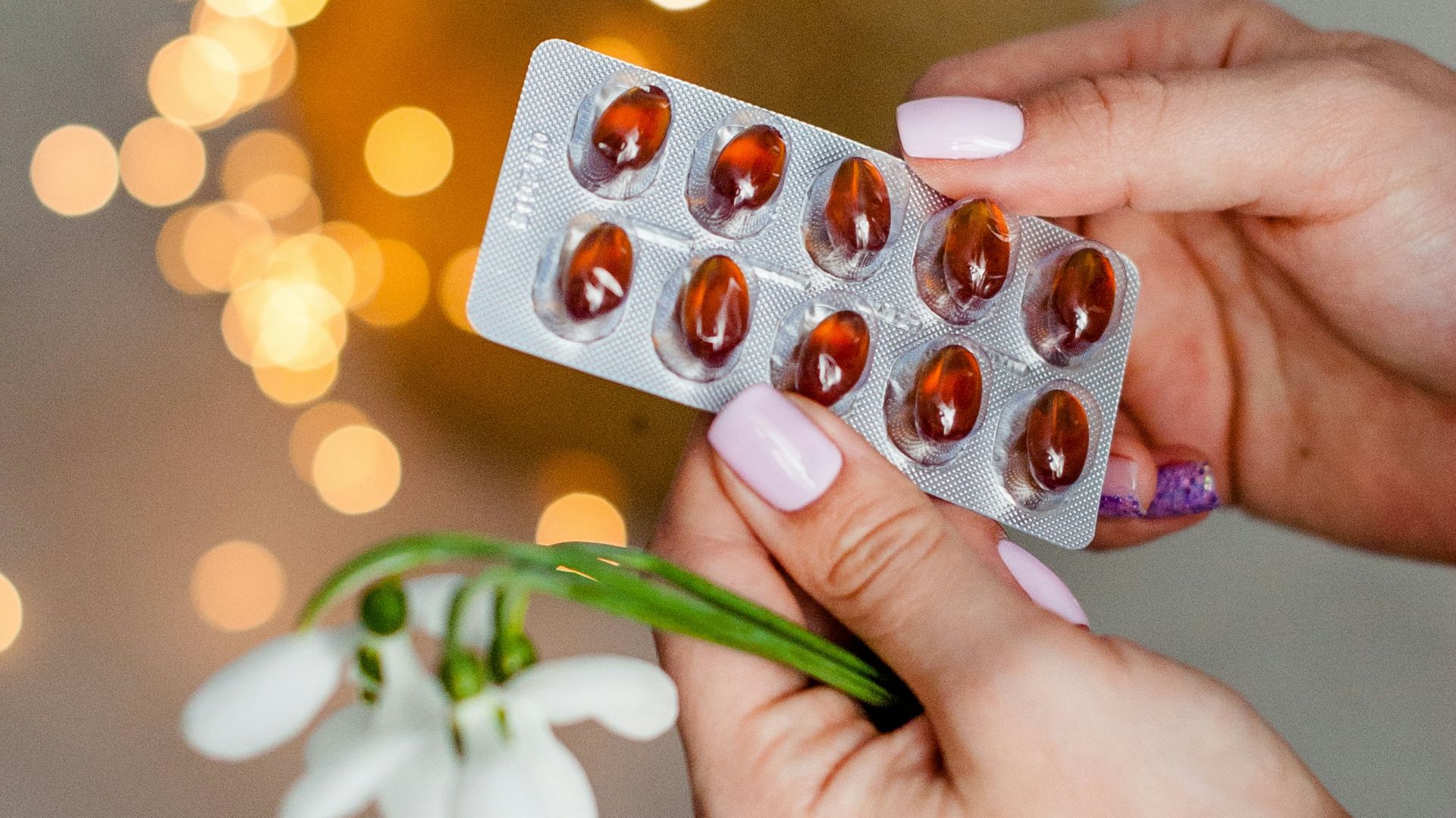 person holding silver blister pack