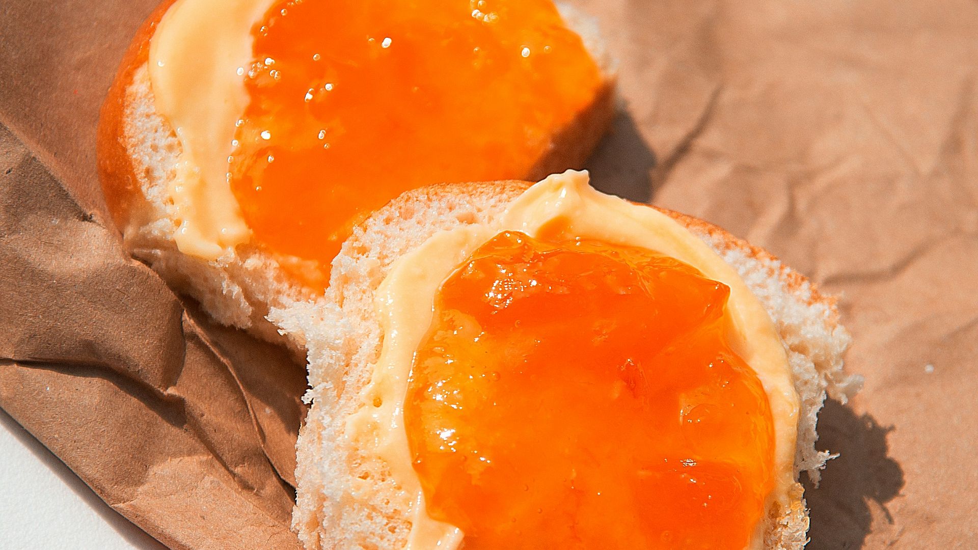 brown bread with white cream on brown paper