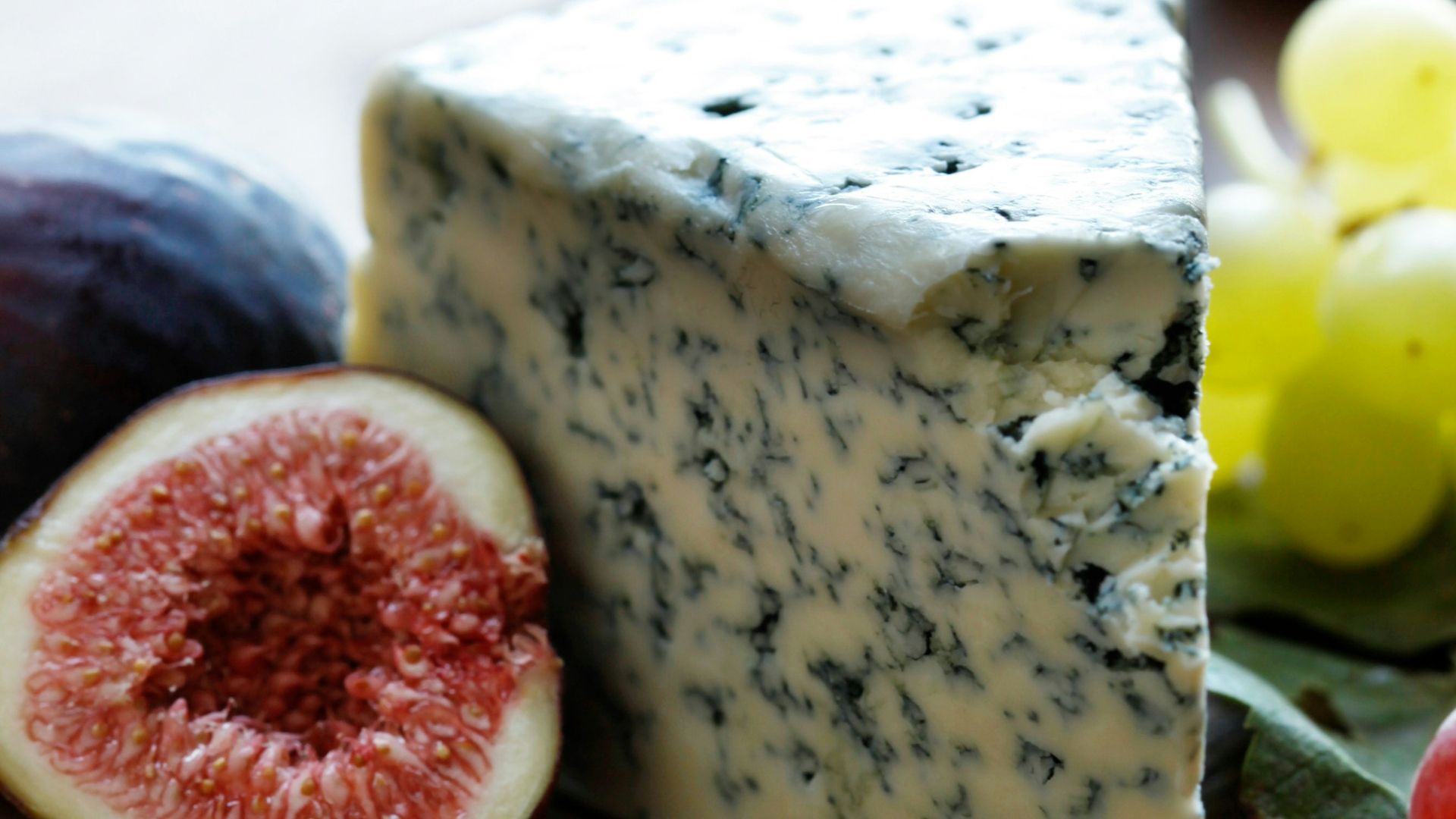 fruits and cheese on wooden surface
