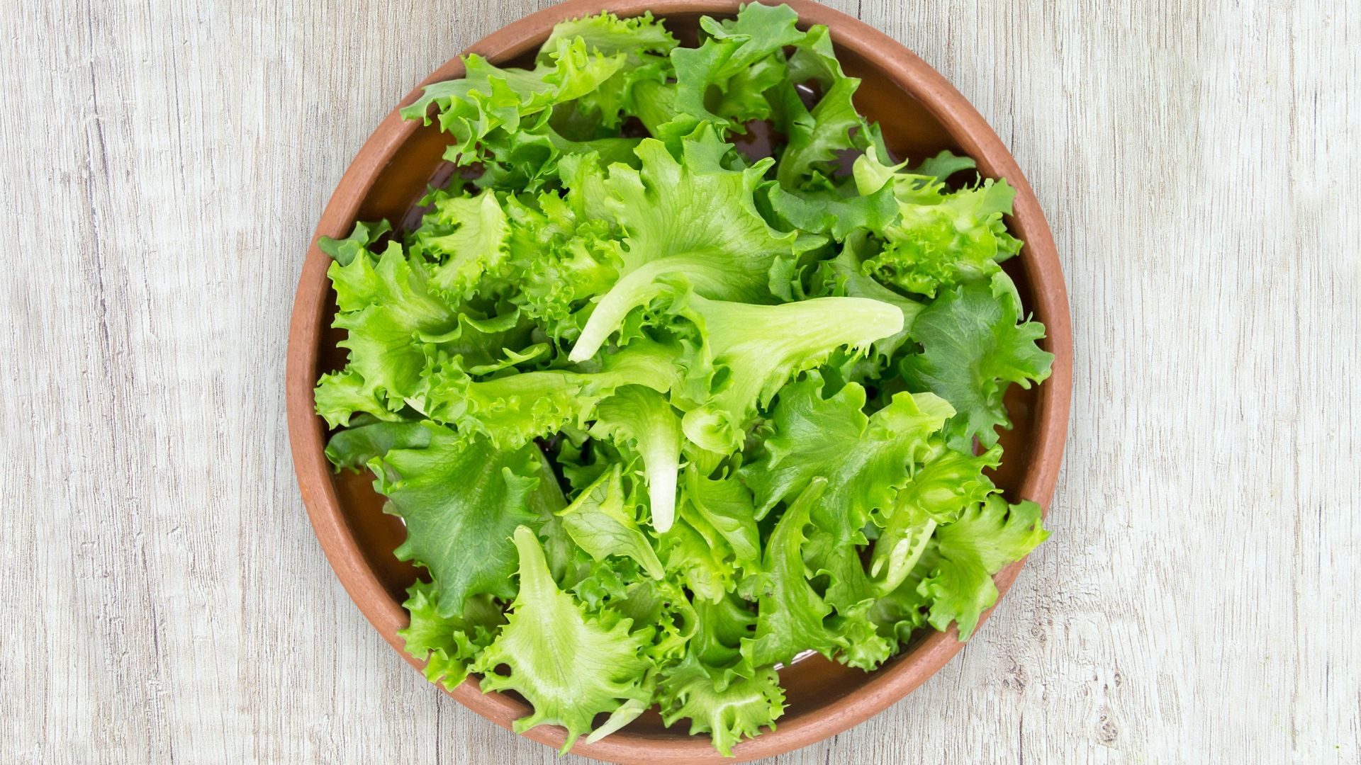 green vegetable on brown round plastic bowl