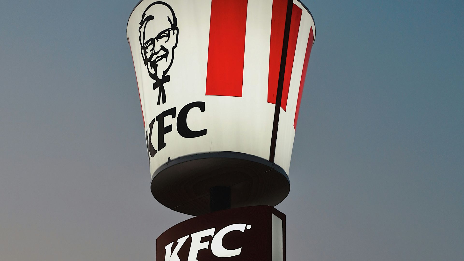a kfc sign with a man's face on it
