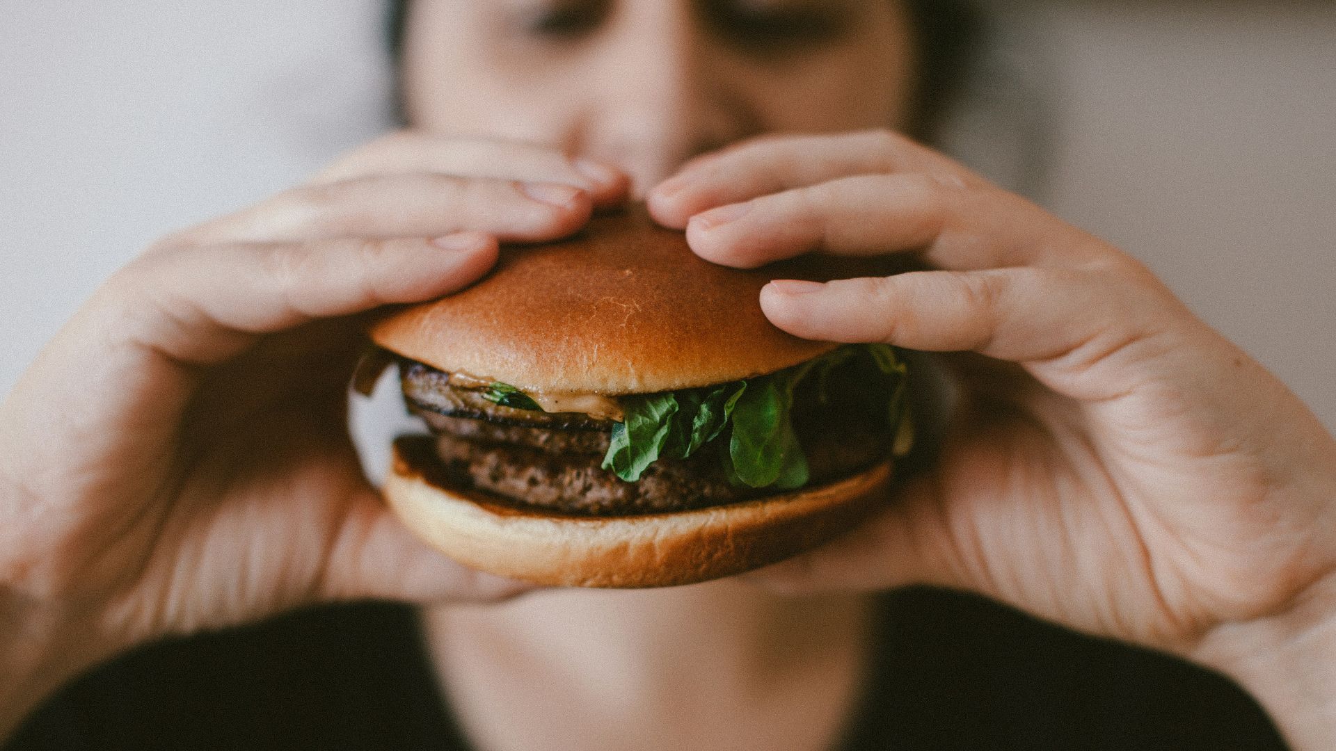 person holding burger