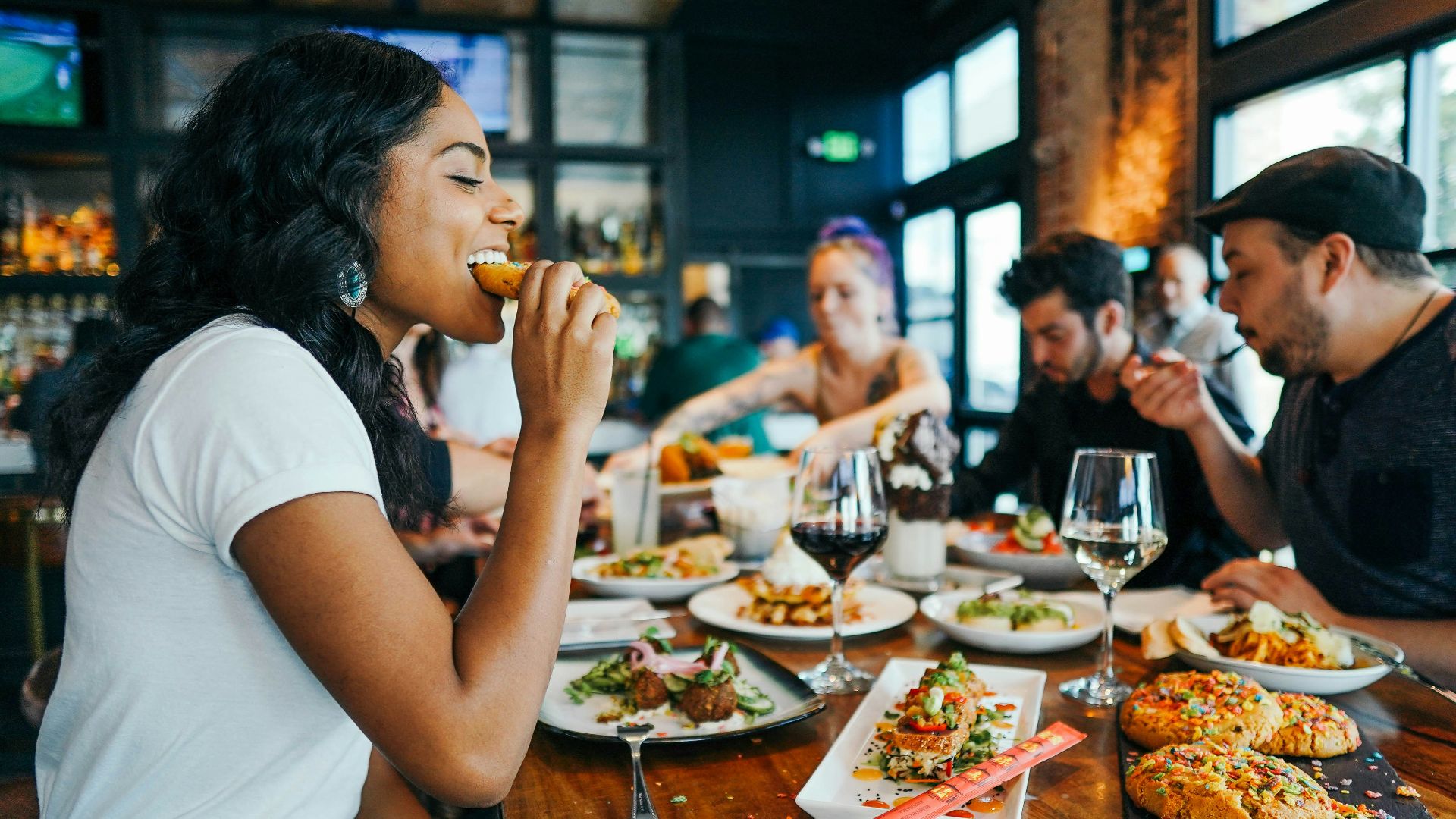 woman in white shirt eating