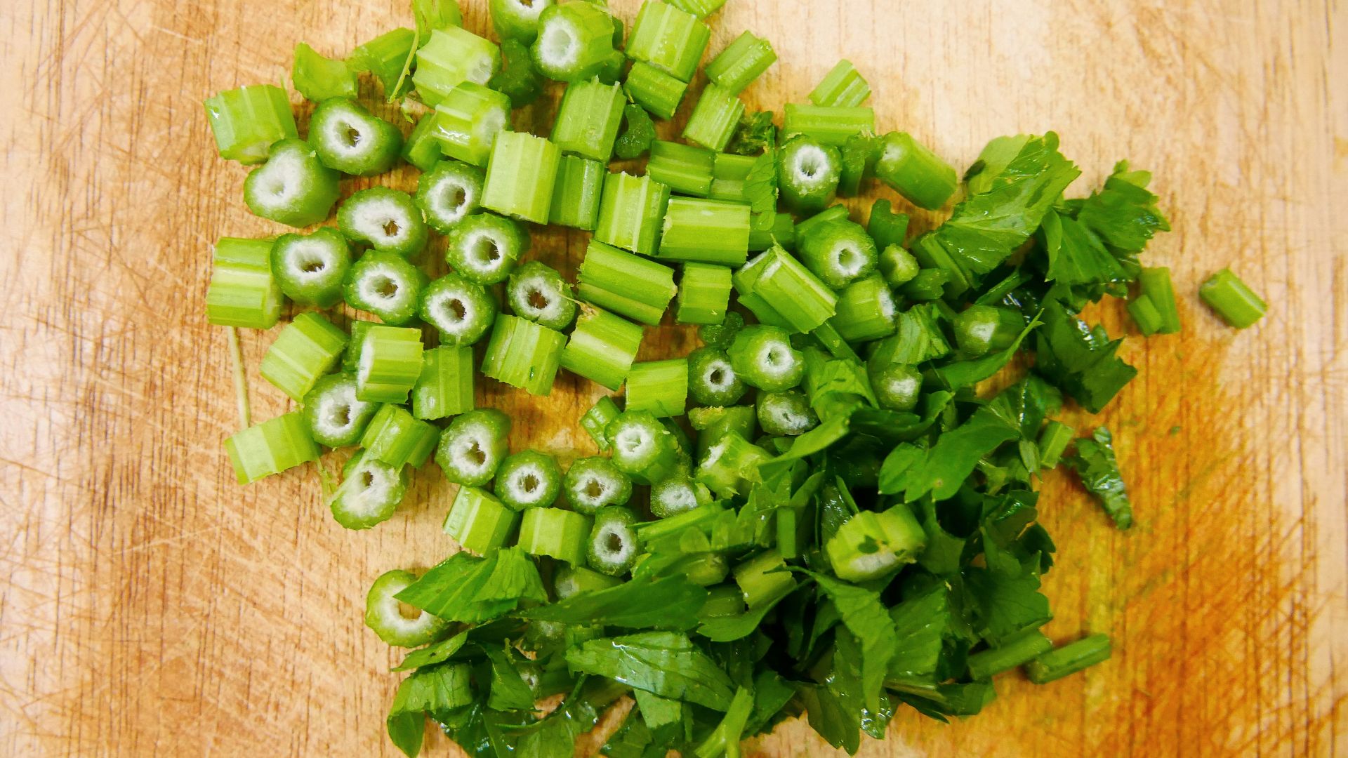 chopped up green vegetables on a cutting board