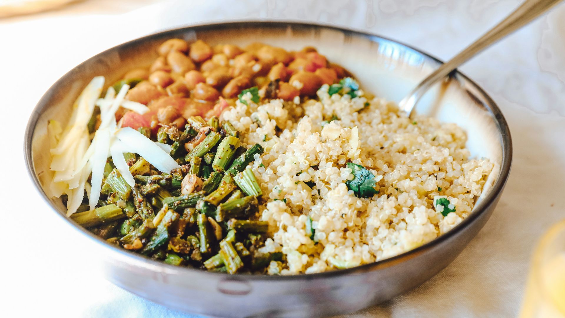 cooked rice with green peas and carrots on stainless steel bowl