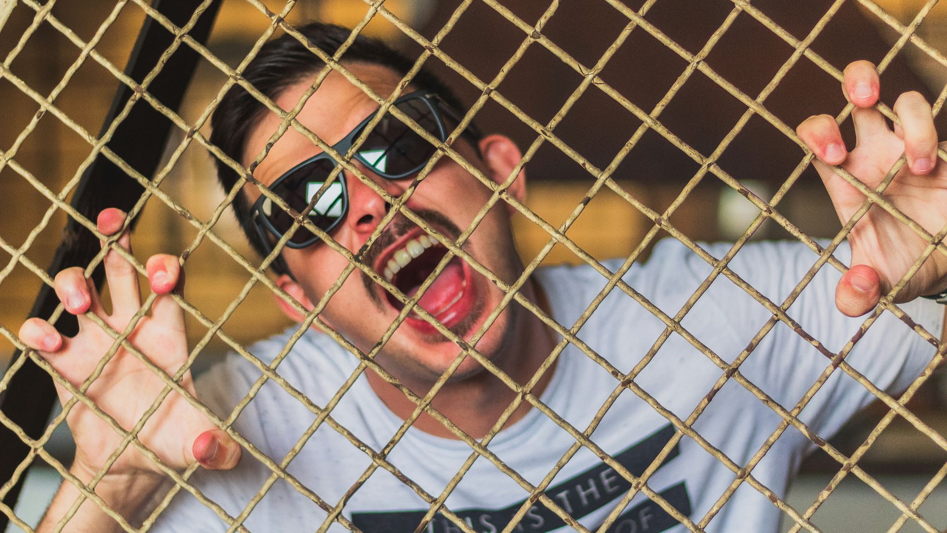man in white crew neck t-shirt wearing black sunglasses
