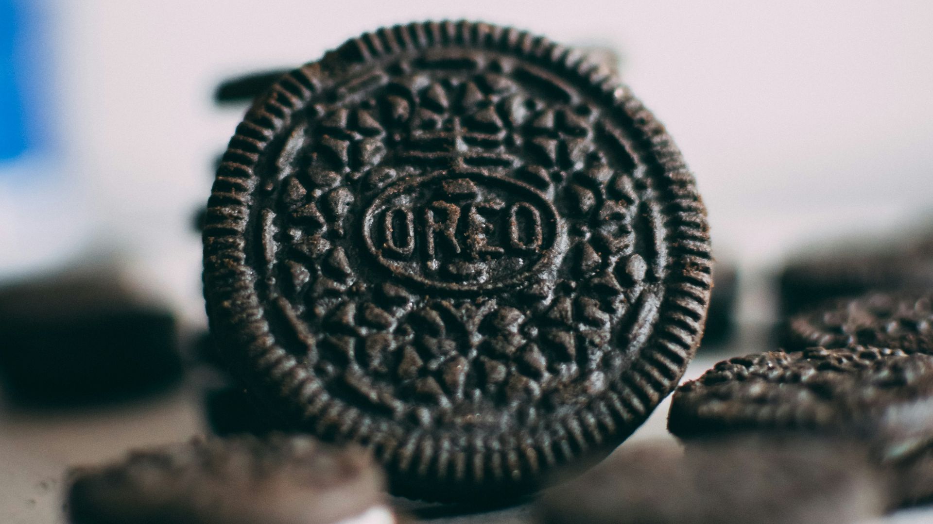 silver round coin on white surface