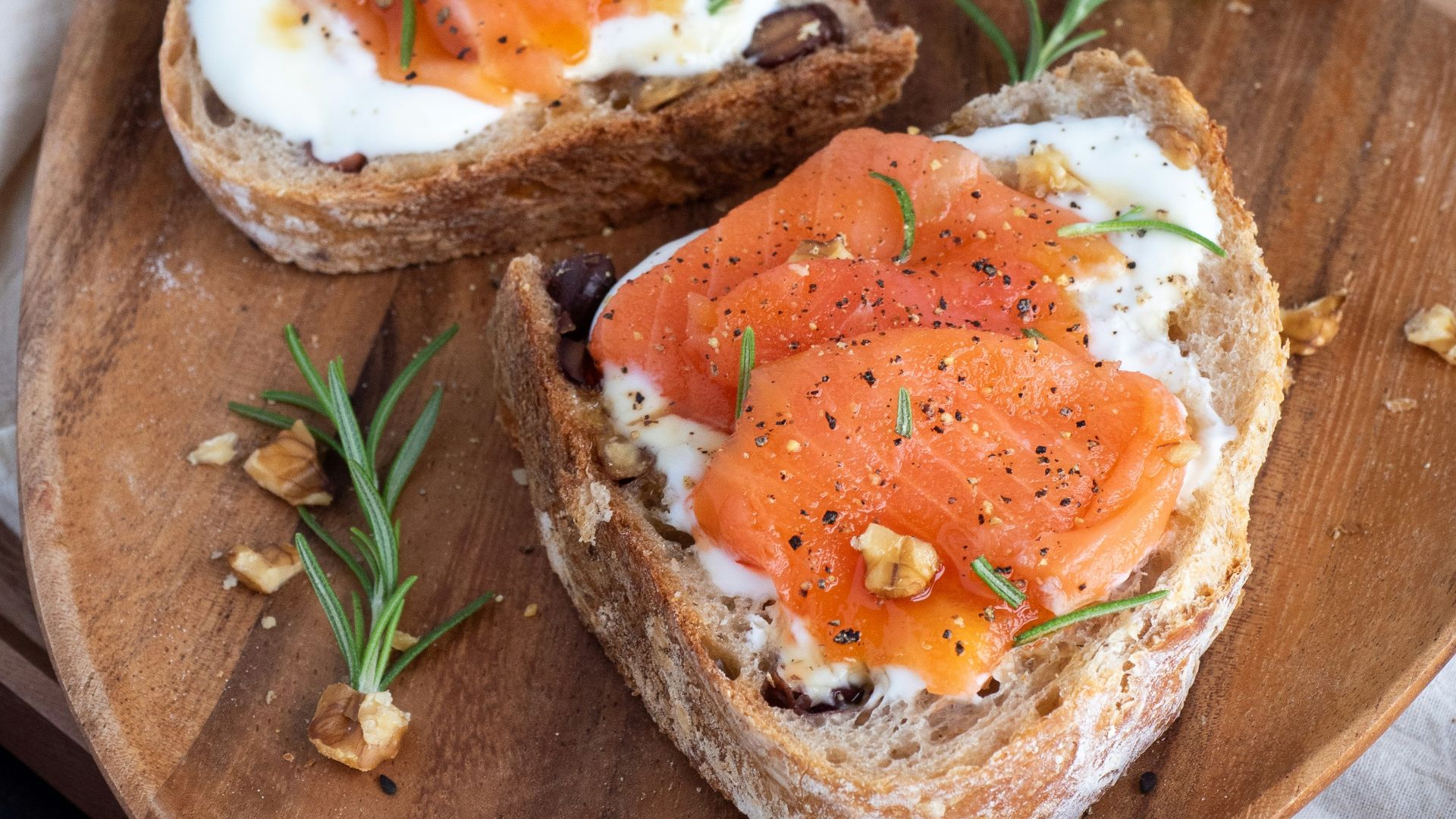 sliced bread with sliced tomato on brown wooden chopping board