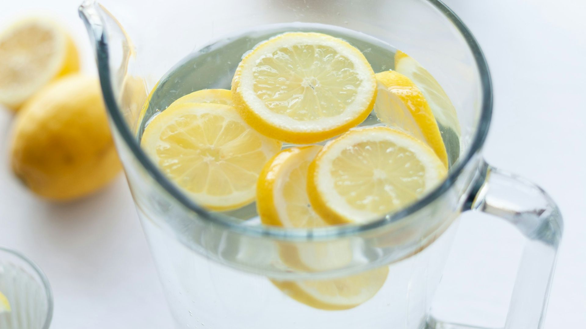 slices of lemons in clear pitcher filled with water