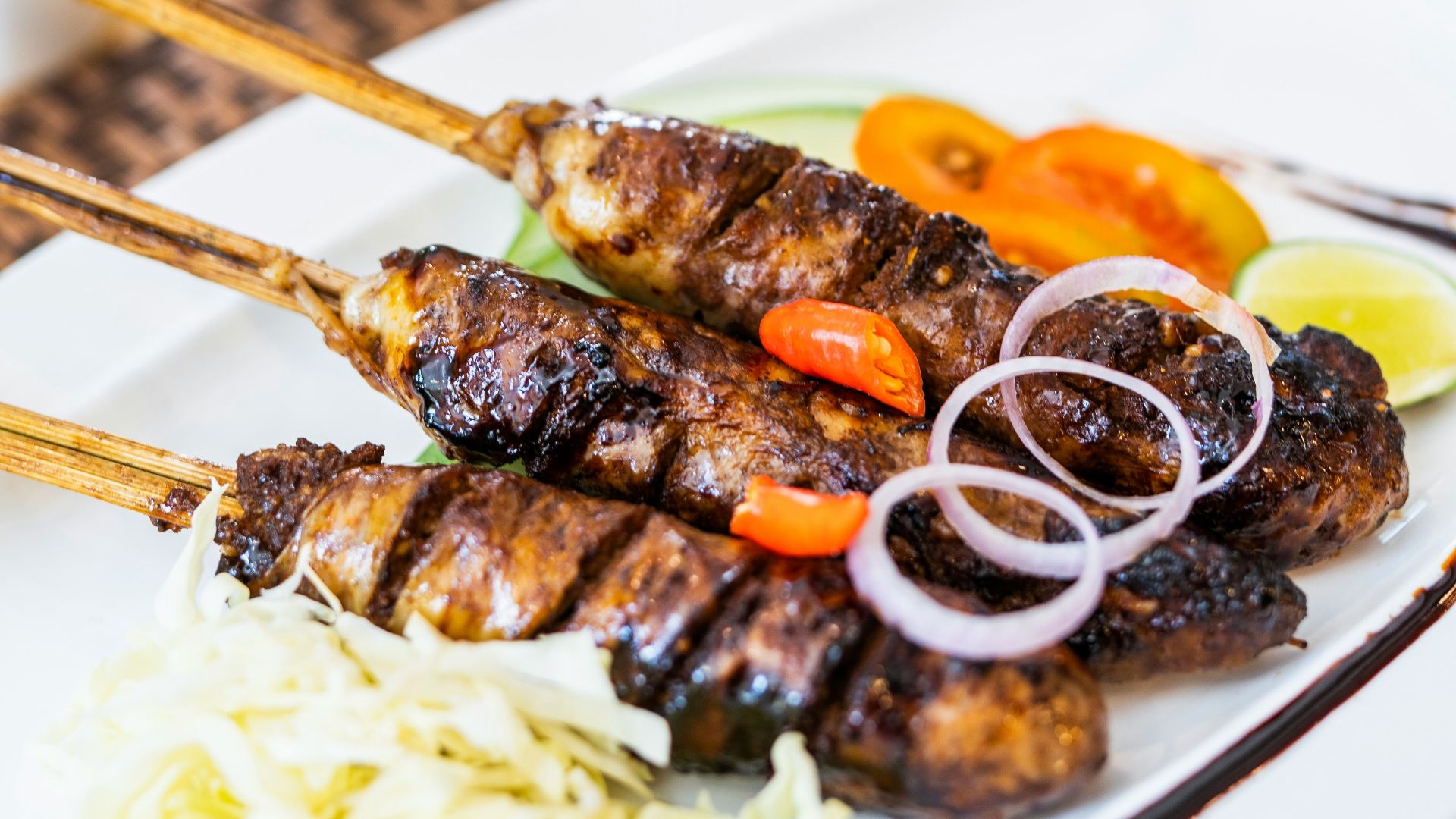 grilled meat with sauce on white ceramic plate