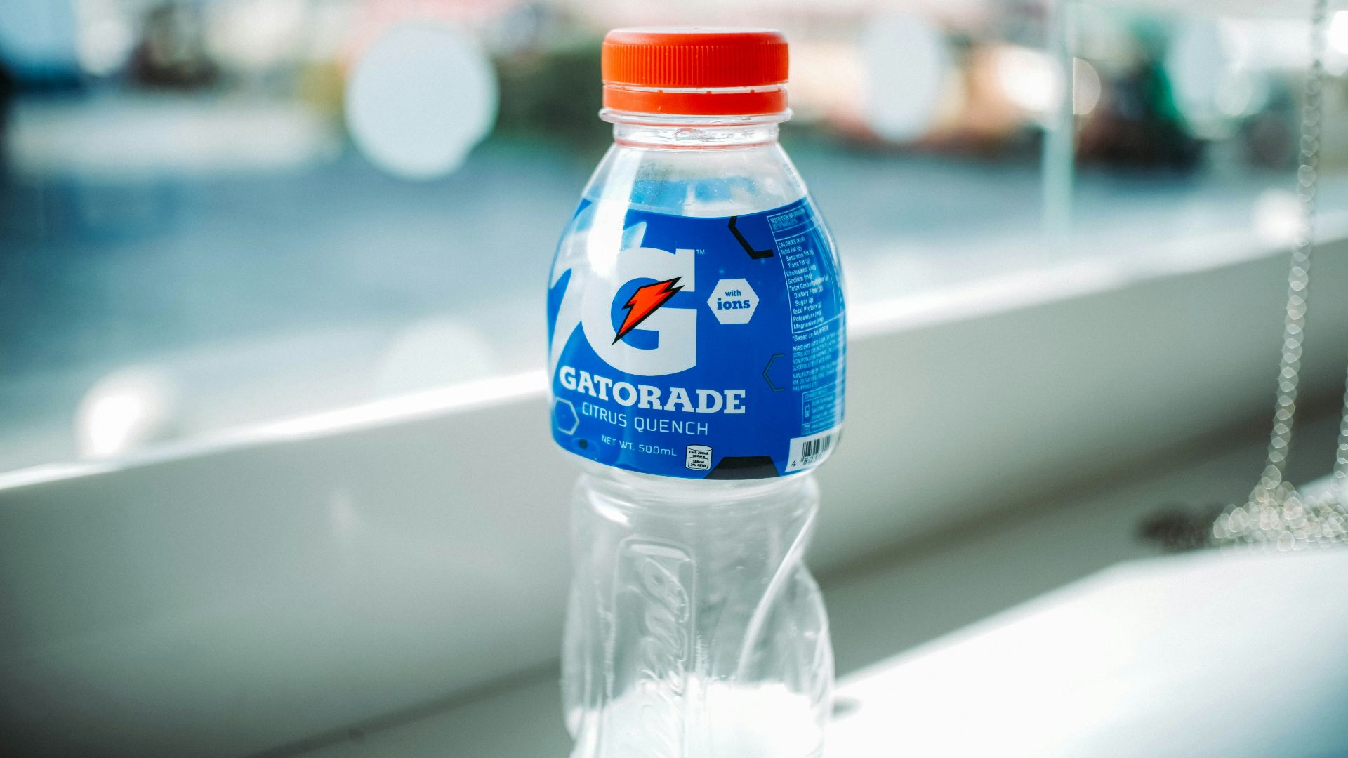 blue labeled plastic bottle on white table