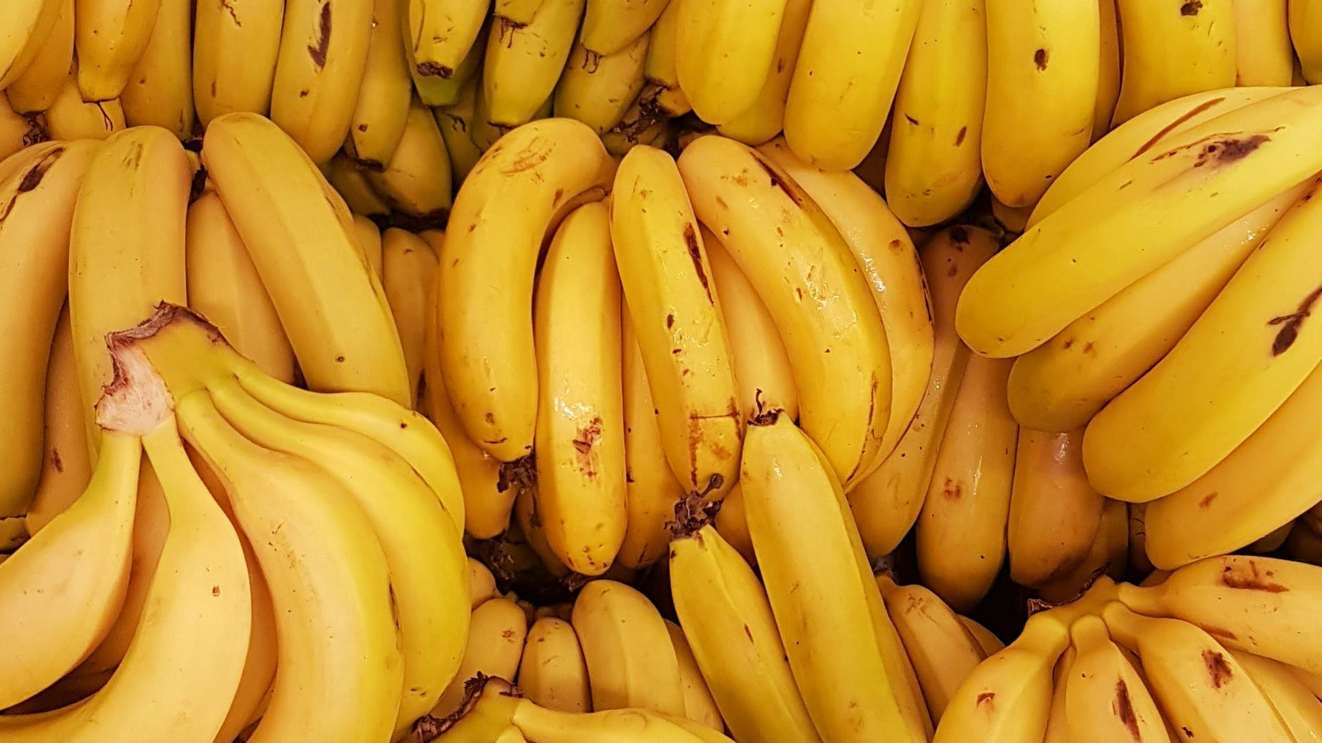 yellow banana fruit on brown wooden table