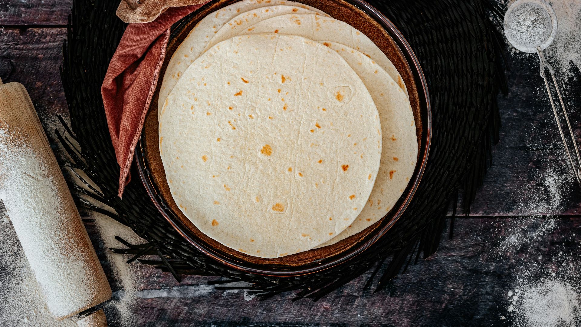 brown woven round basket on black and gray textile