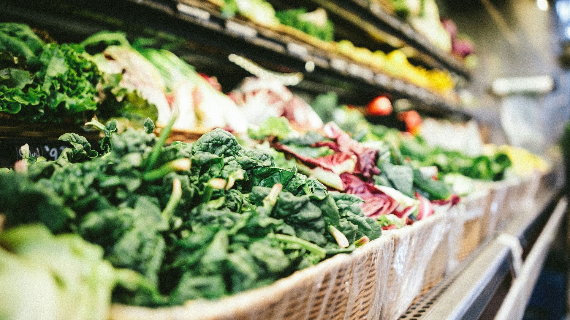row of vegetables placed on multilayered display fridge
