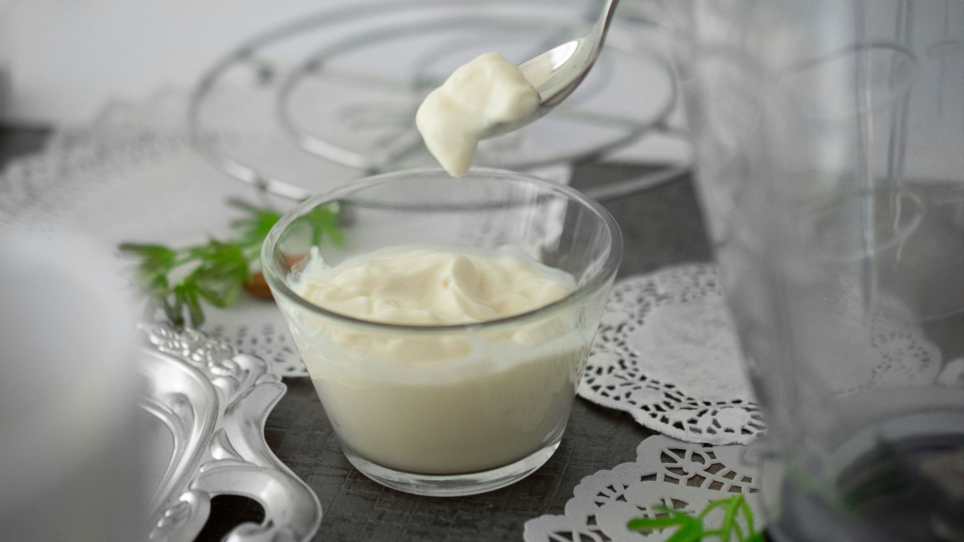 close-up photo of white cream in clear shot glass