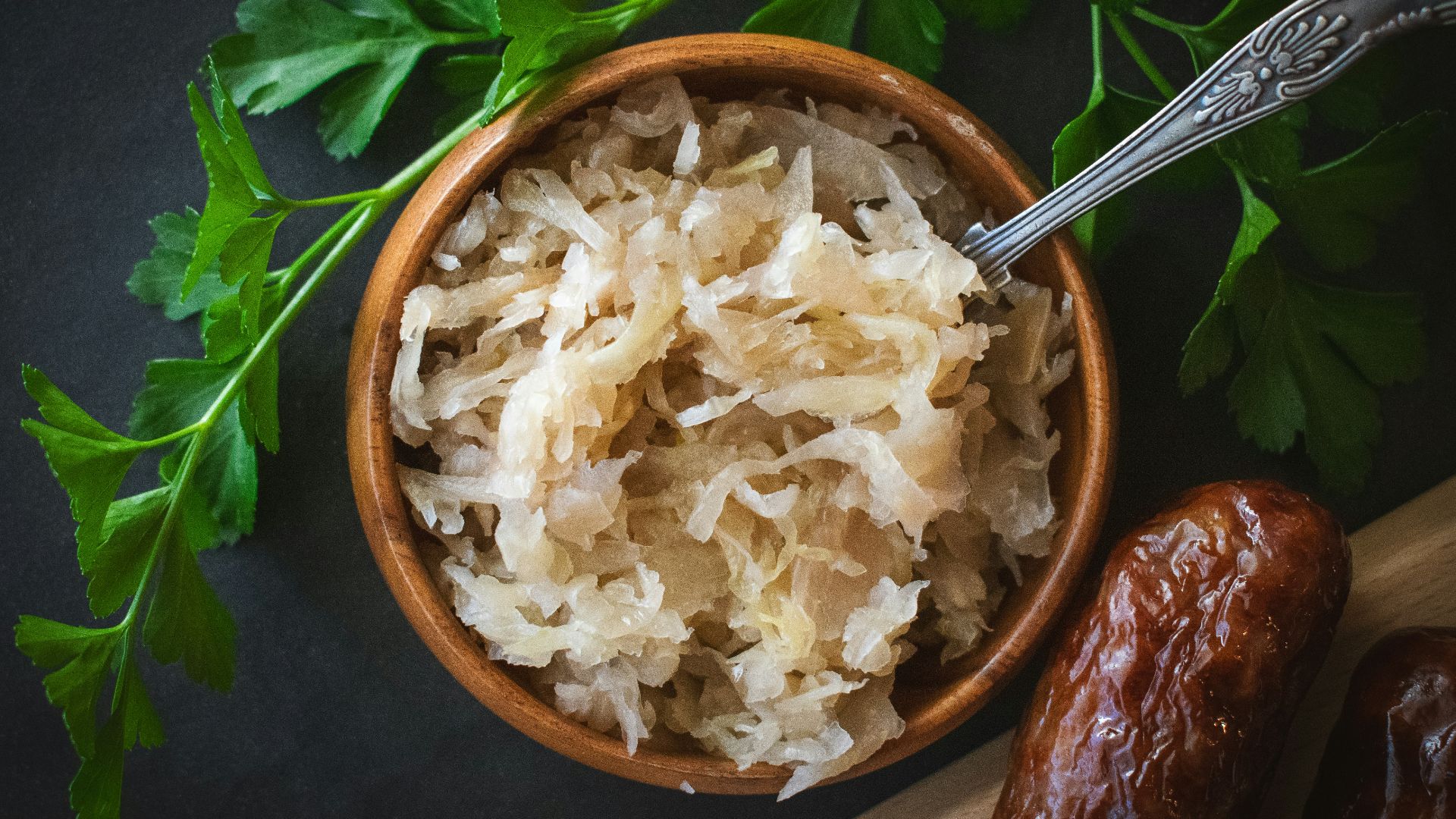 a wooden bowl filled with rice next to a spoon