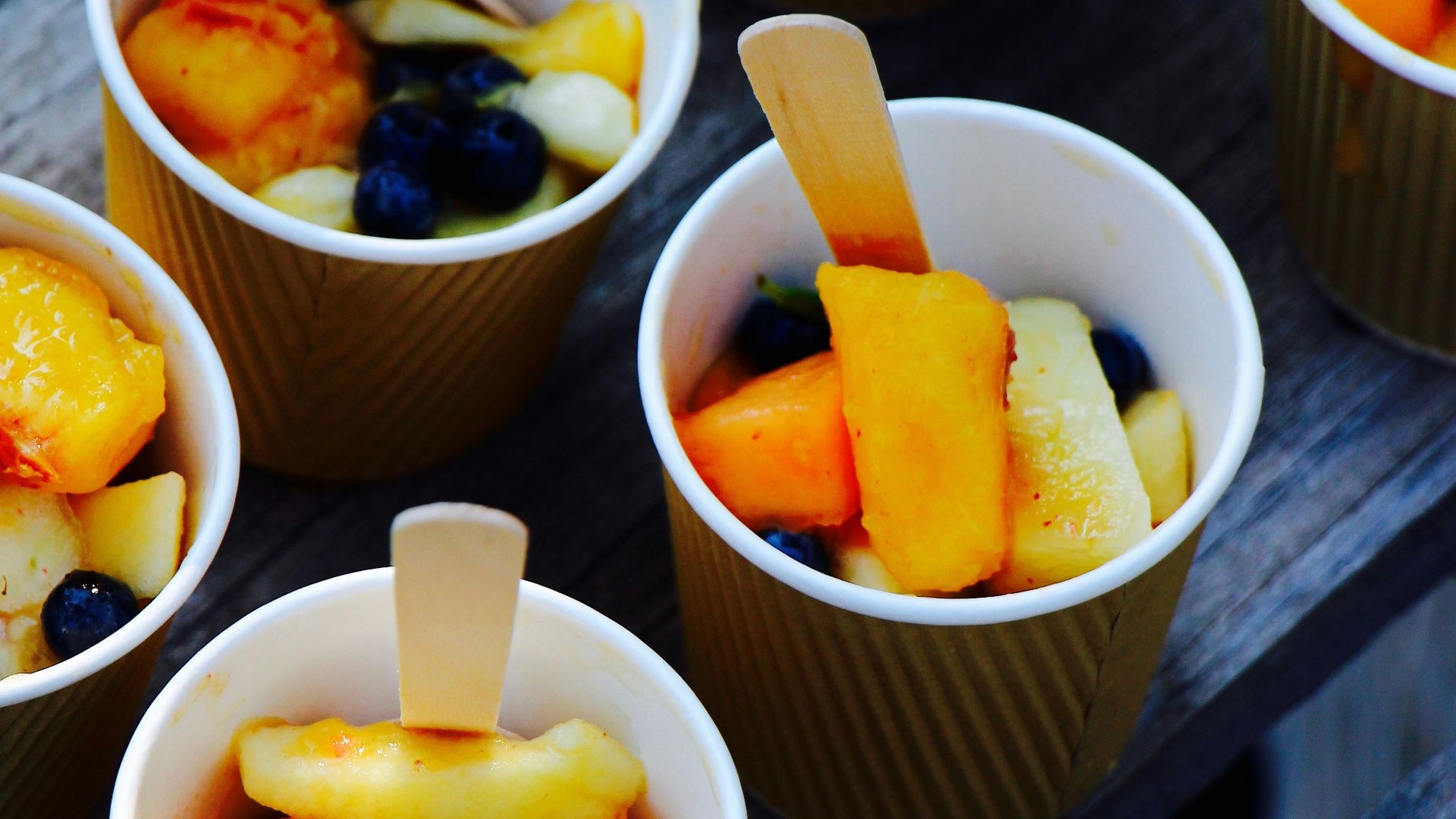 plastic cups on wooden surface