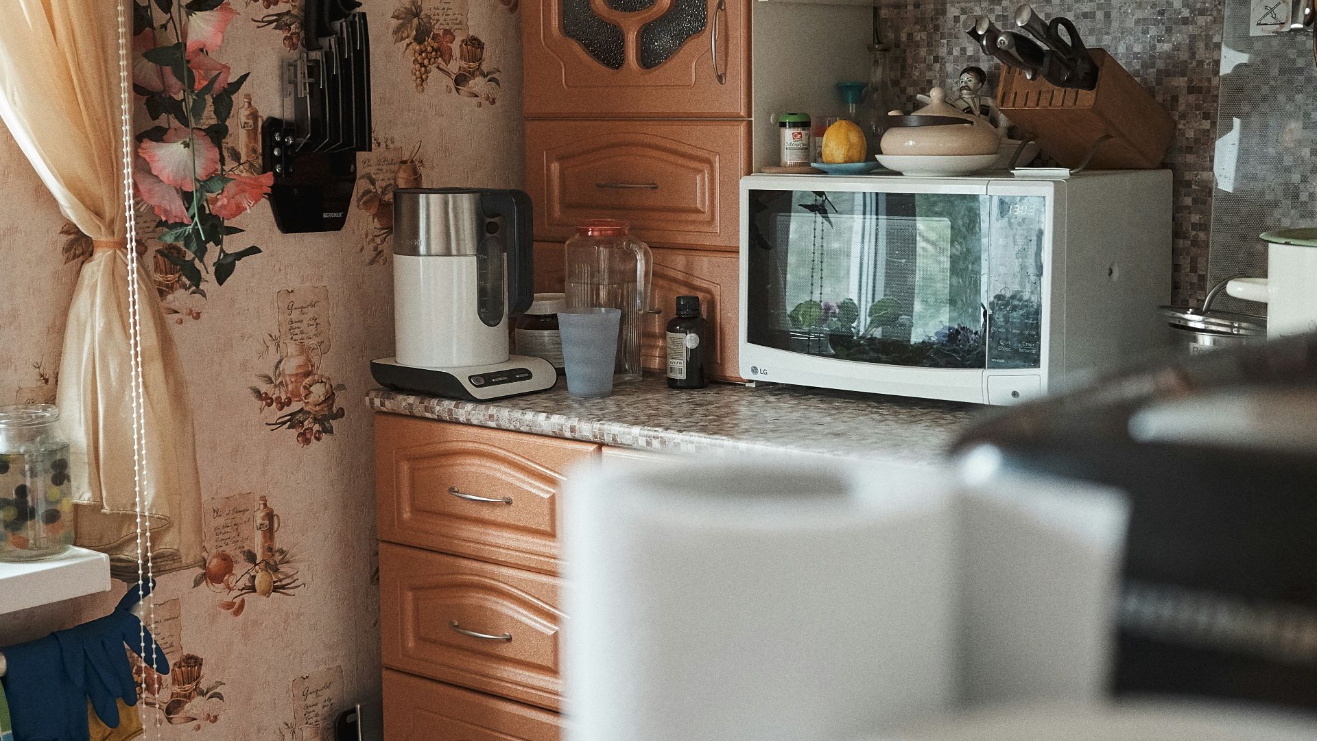 white microwave oven on brown wooden cabinet