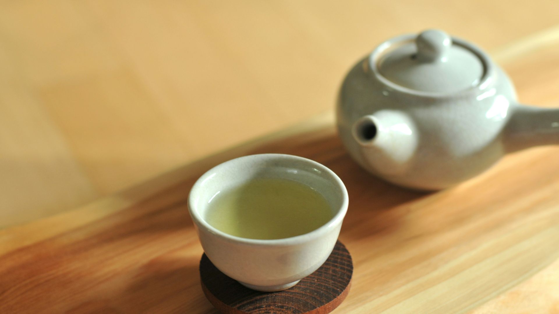 white ceramic teacup on brown wooden table
