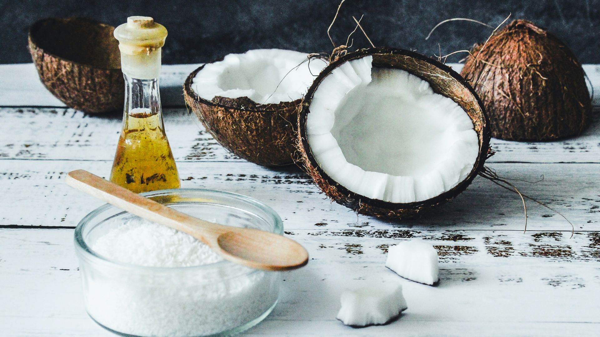 white powder in clear glass jar beside brown wooden spoon