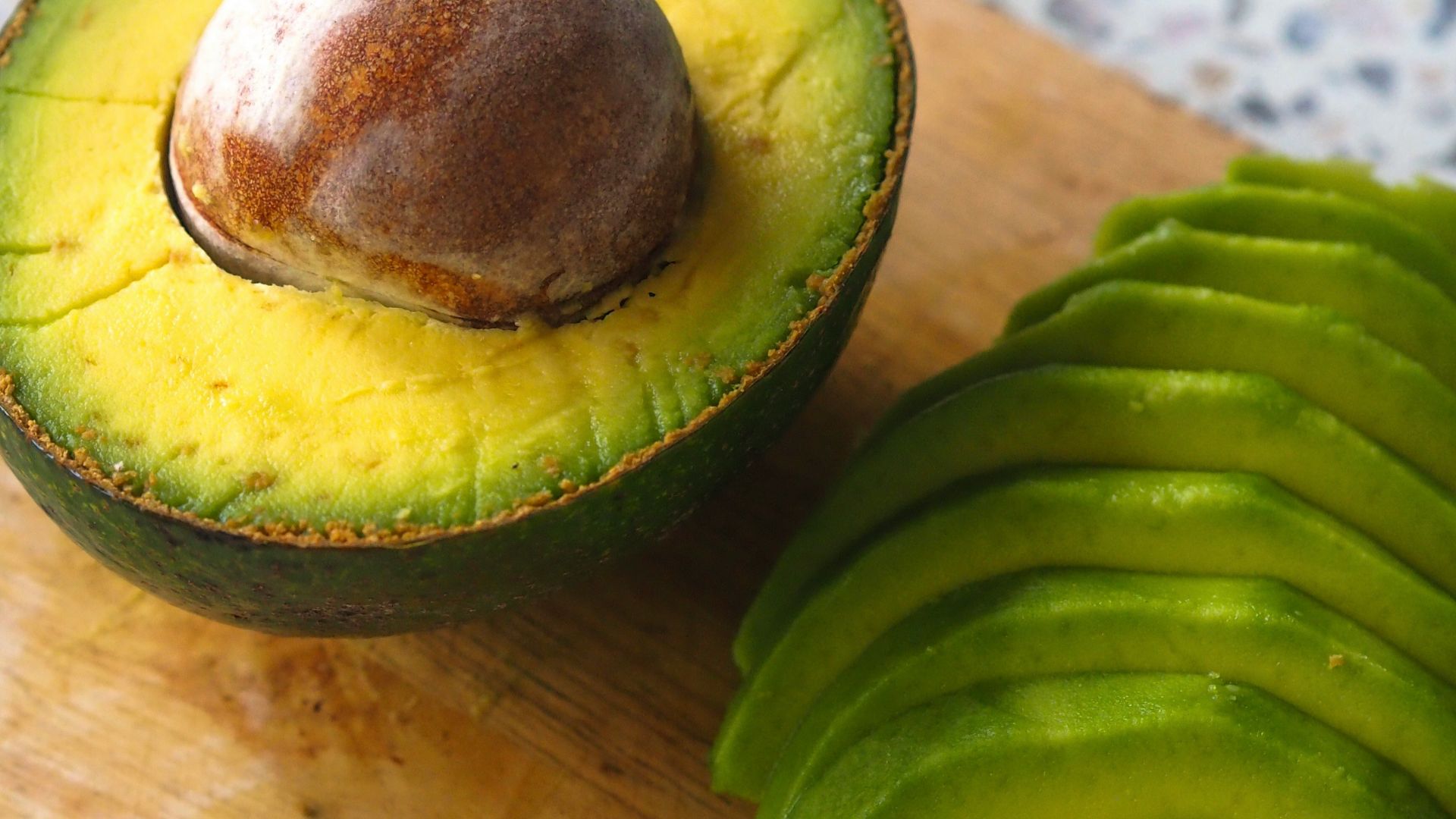 an avocado cut in half on a cutting board