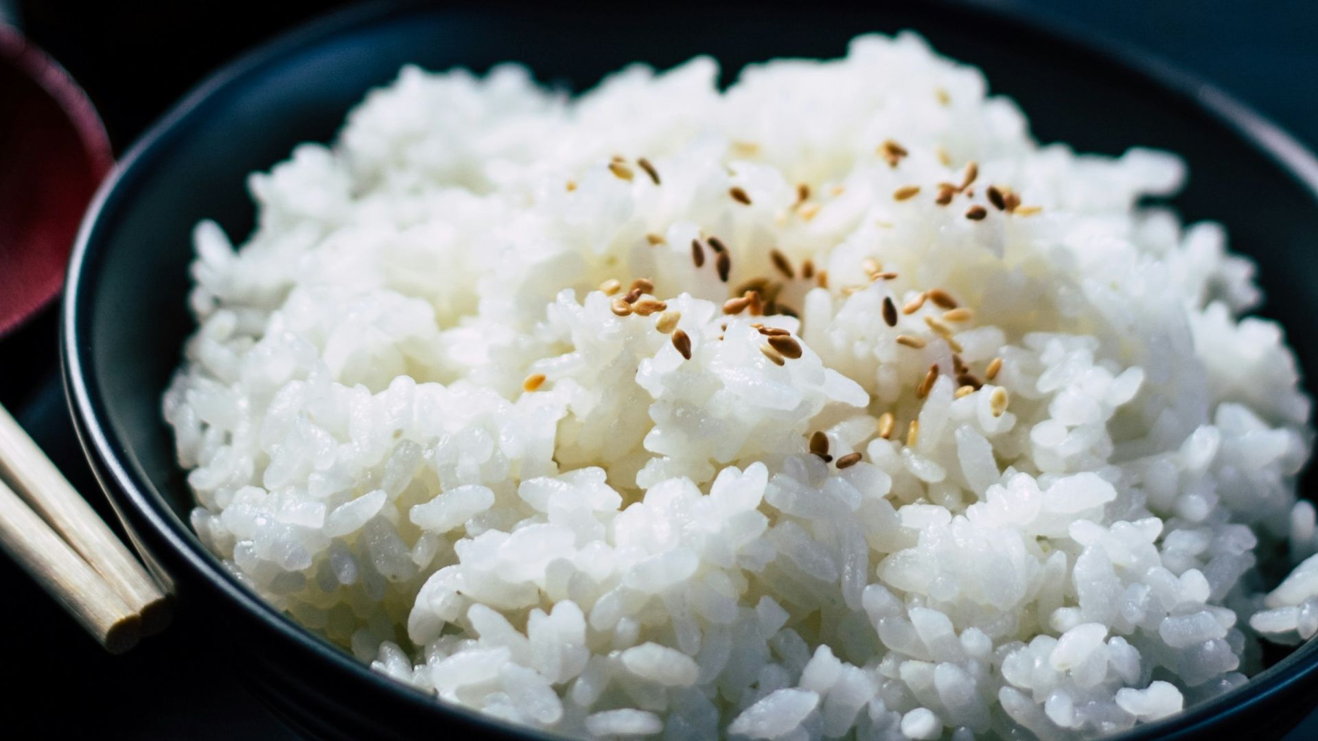 rice with sesame in black bowl