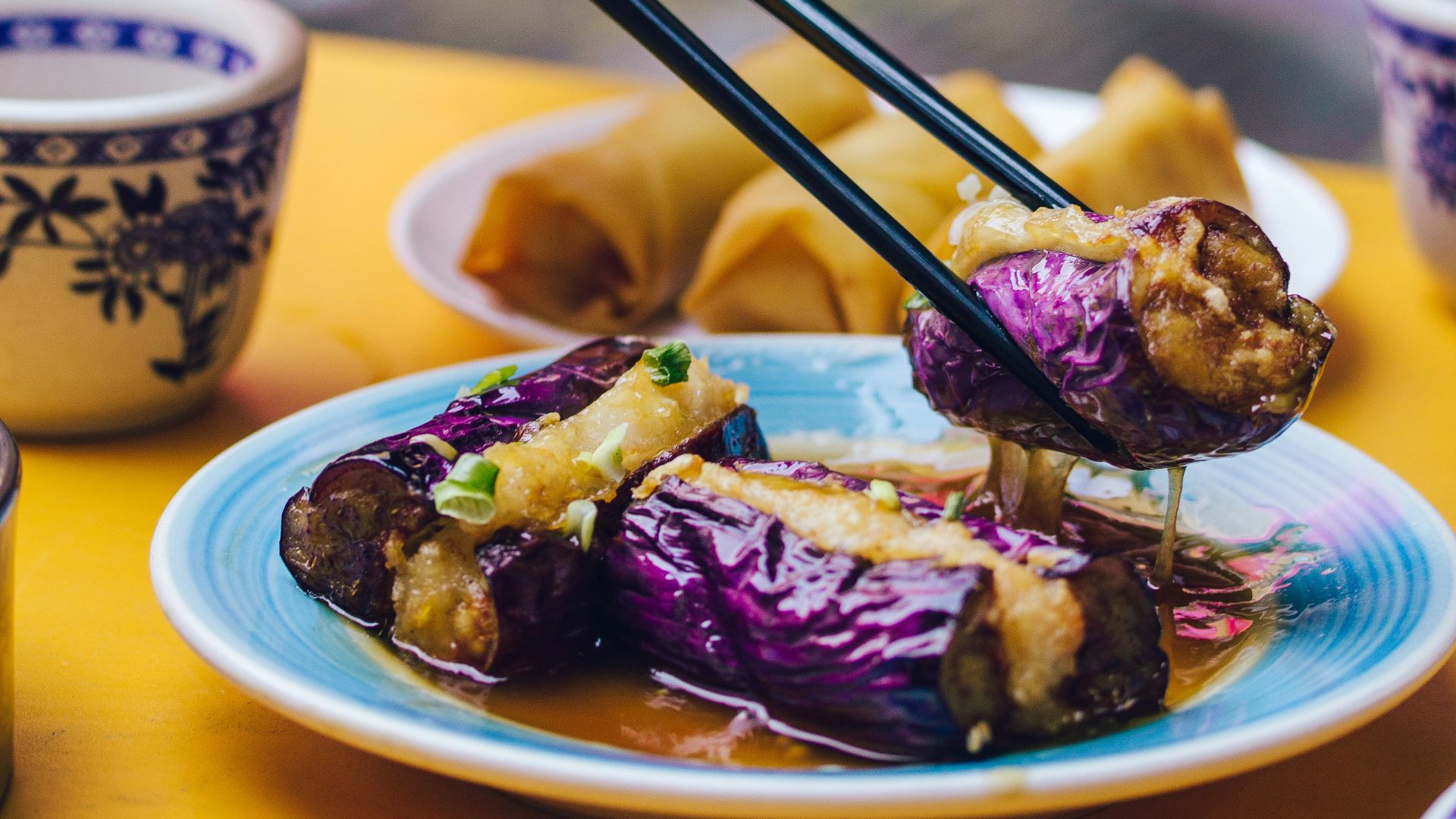 man eating food using chopsticks